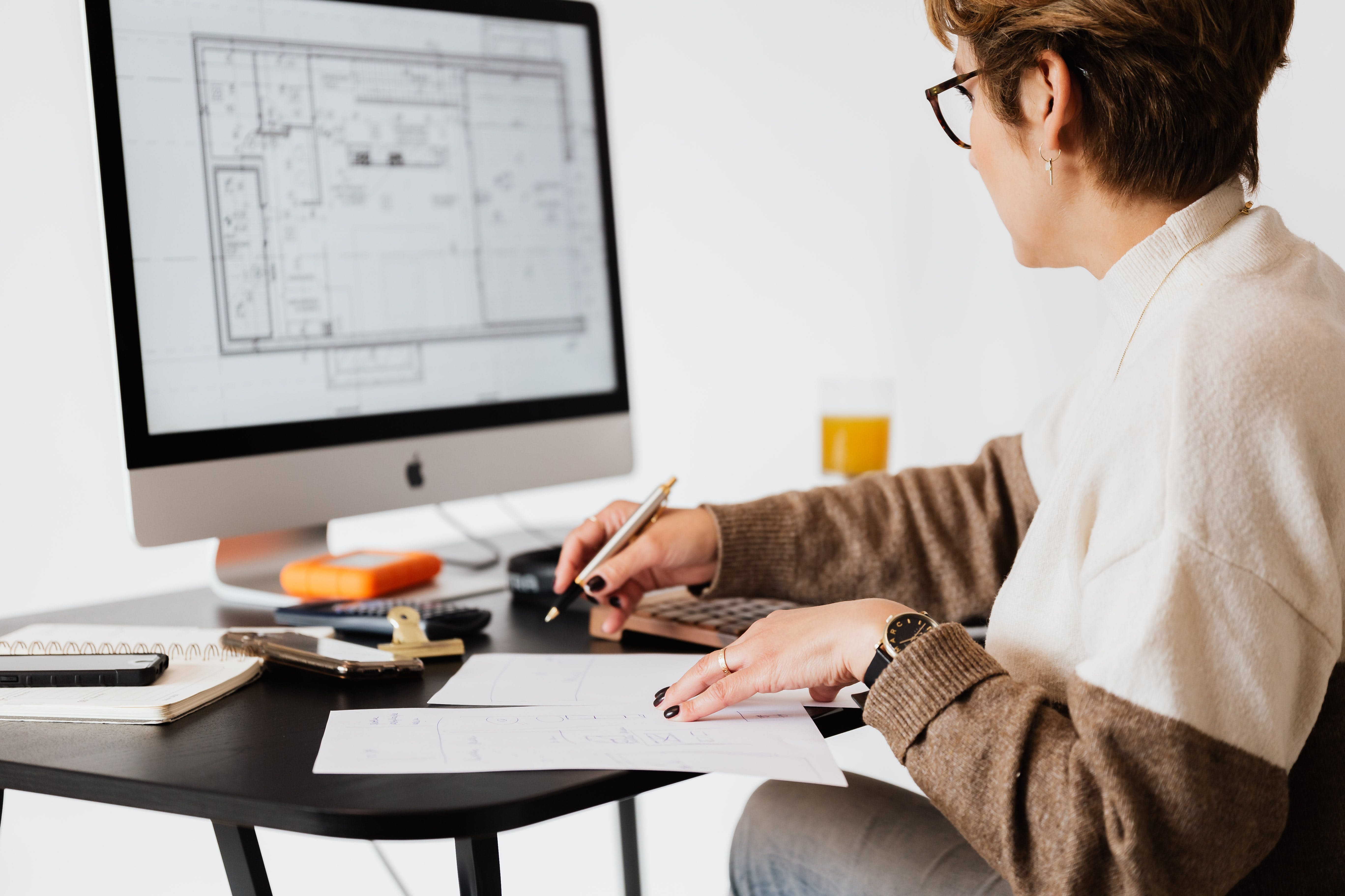 A woman studying a house floor plan