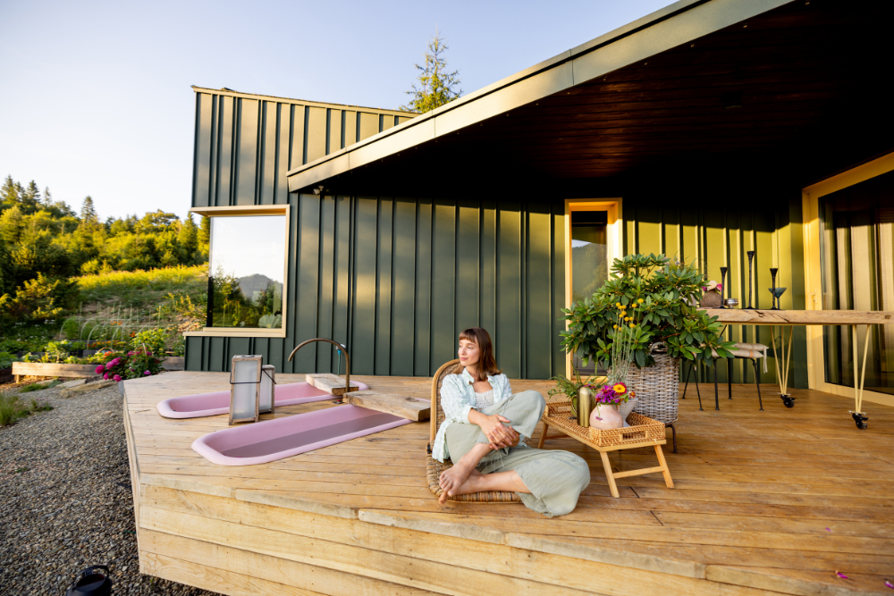 family relaxing on cabin porch in mountains