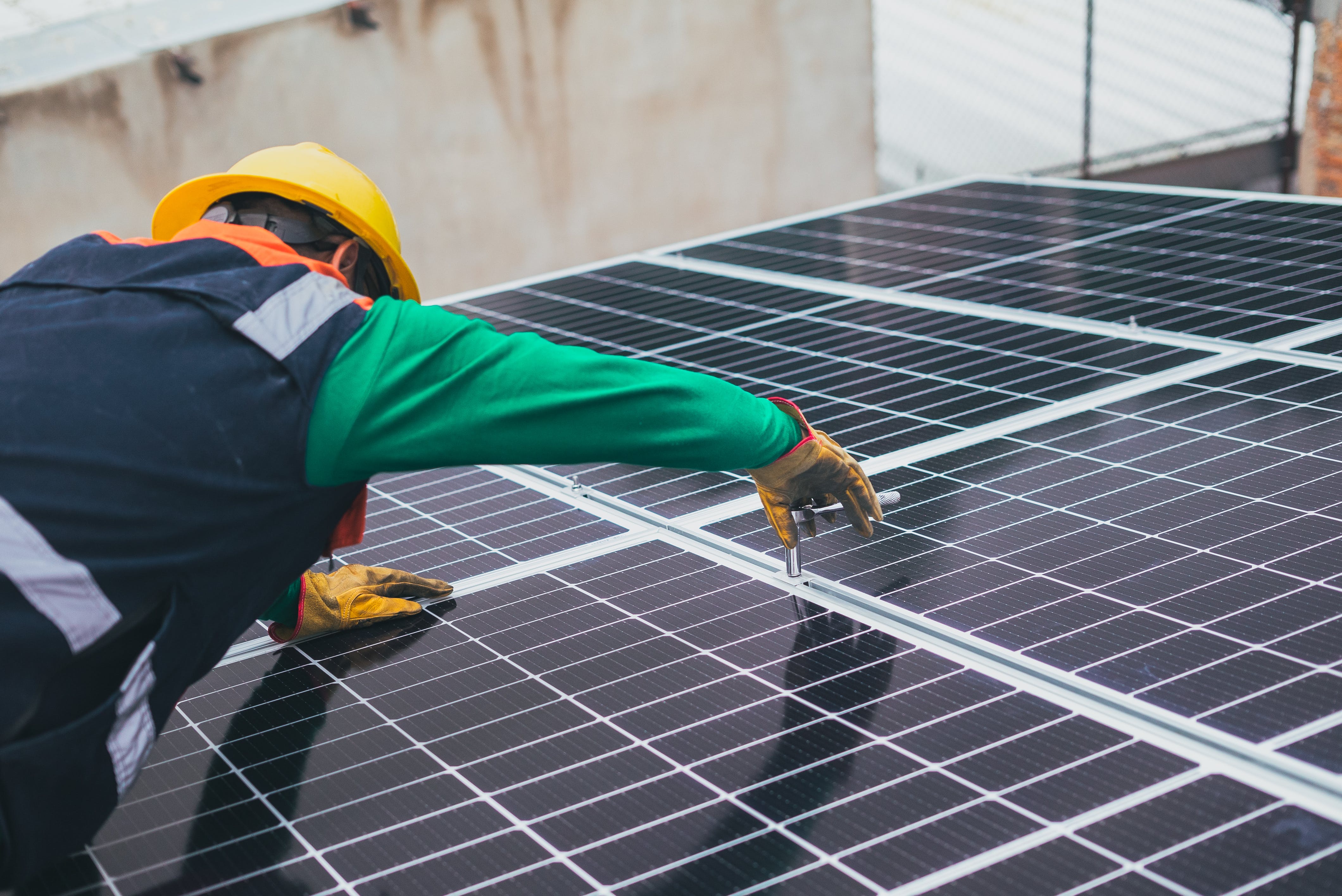 man-installs-solar-panels