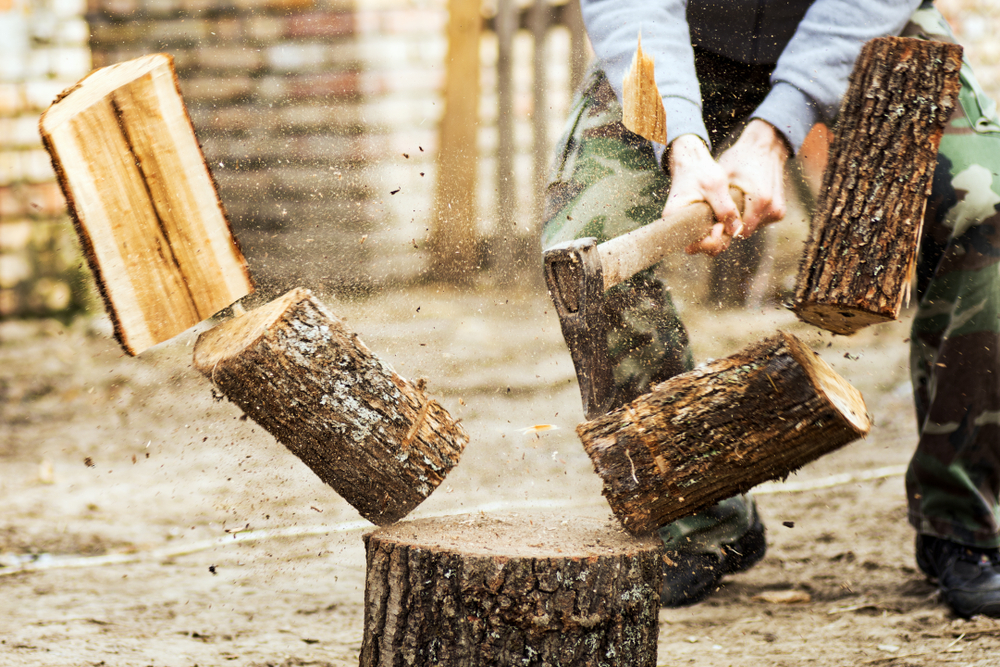 Man cutting log