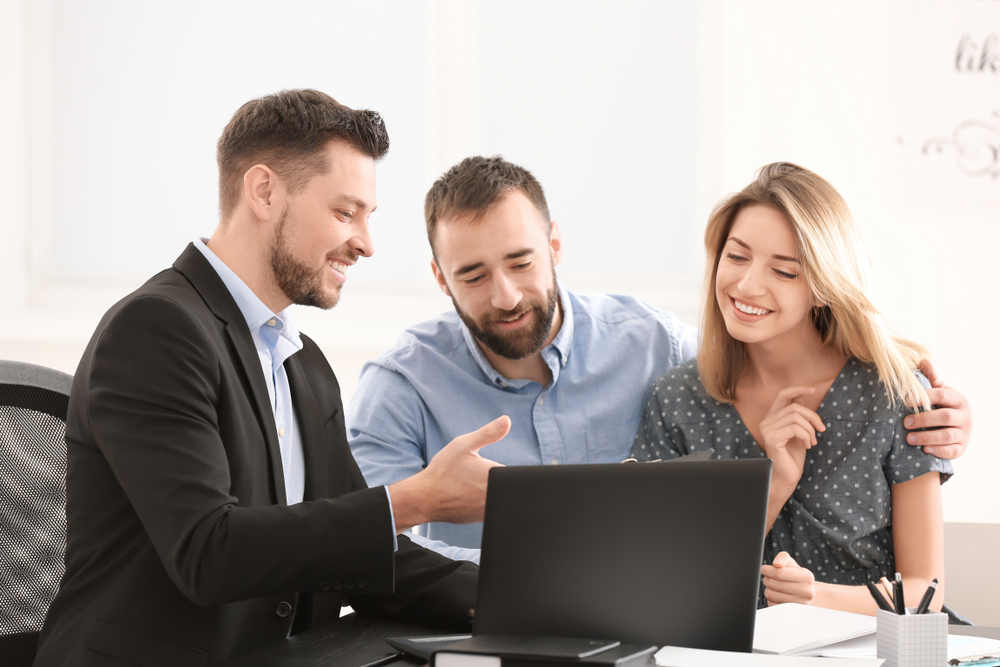 a realtor explaining mortgages to a couple