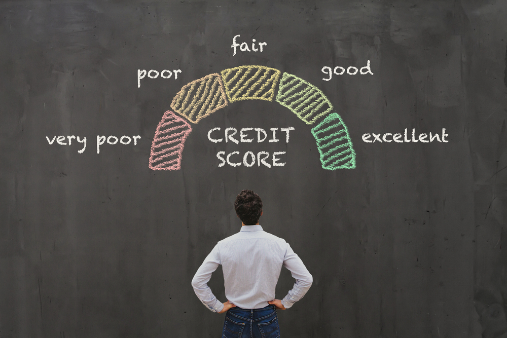 a man staring on a credit score meter gauge written on a black board