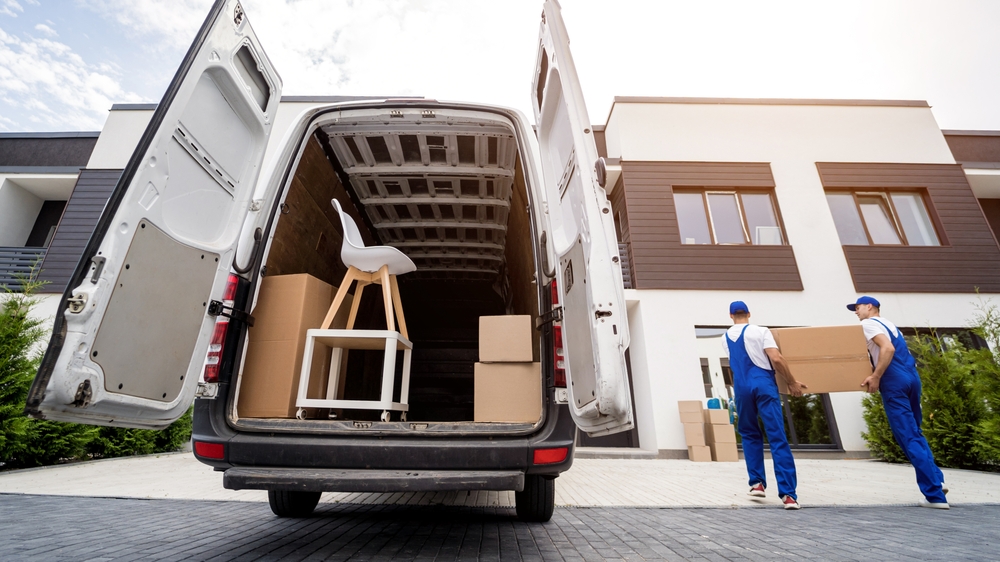 a moving company unloads boxes from their truck