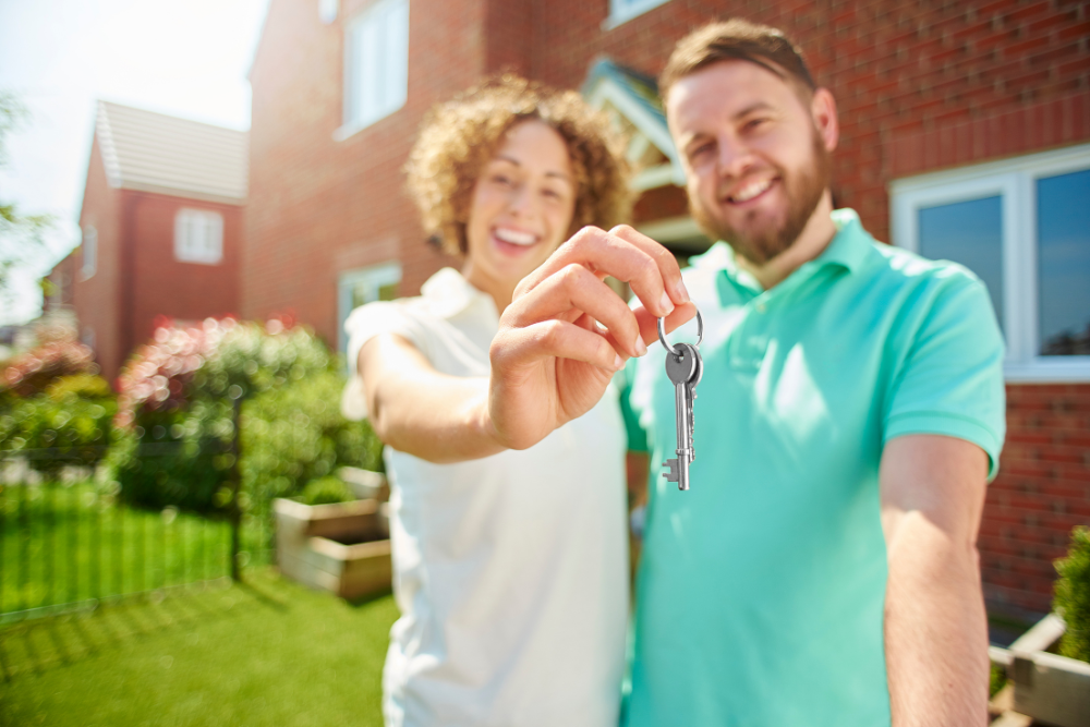 Couple holding a key to a new home