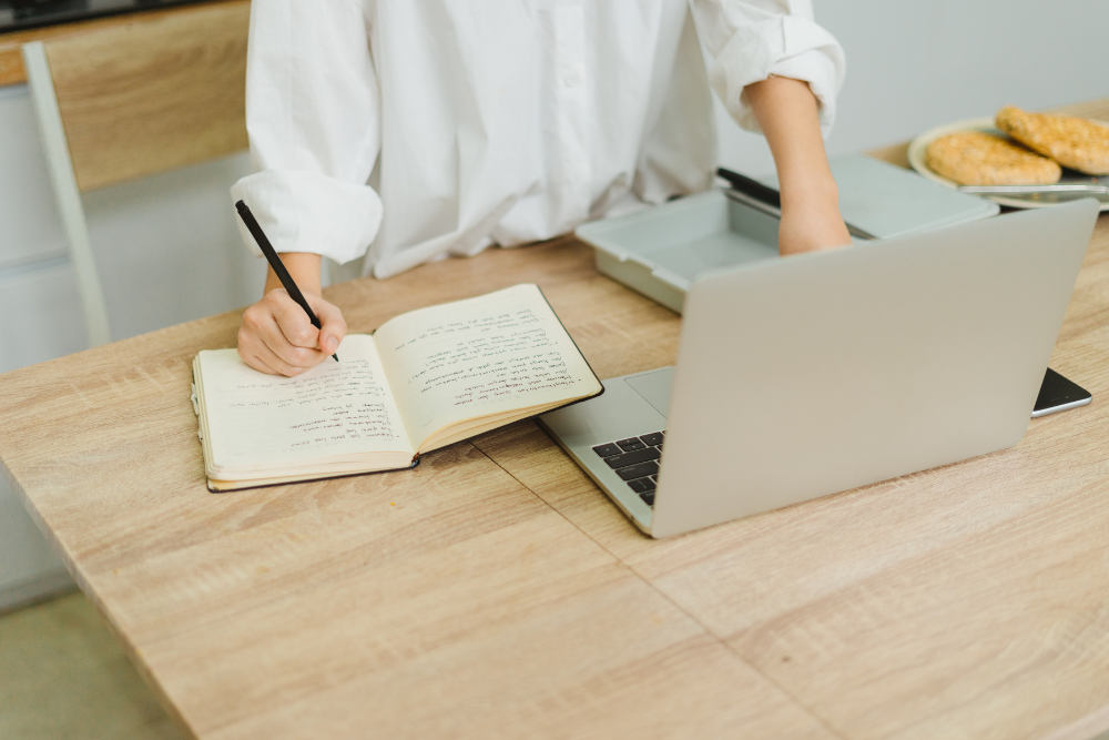 woman on laptop with documentation