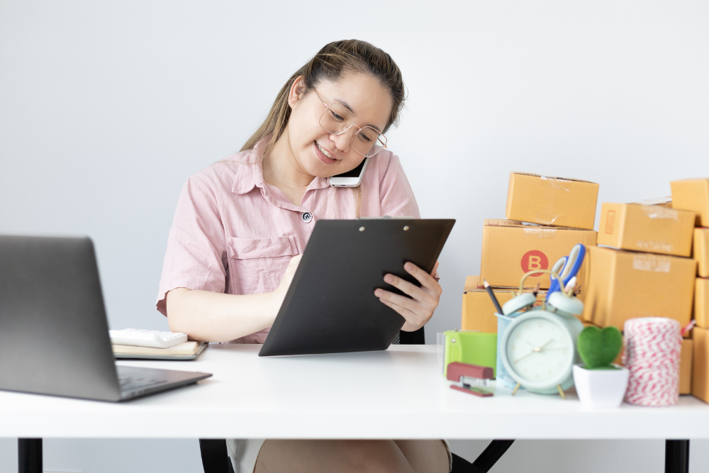 woman organizing documents on her laptop