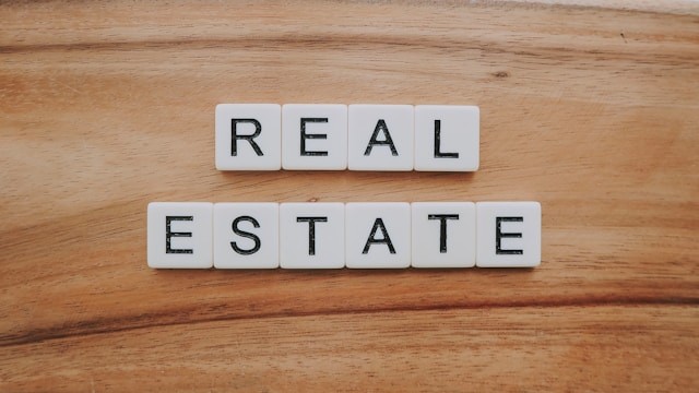 White tiles with letters forming ‘real estate’