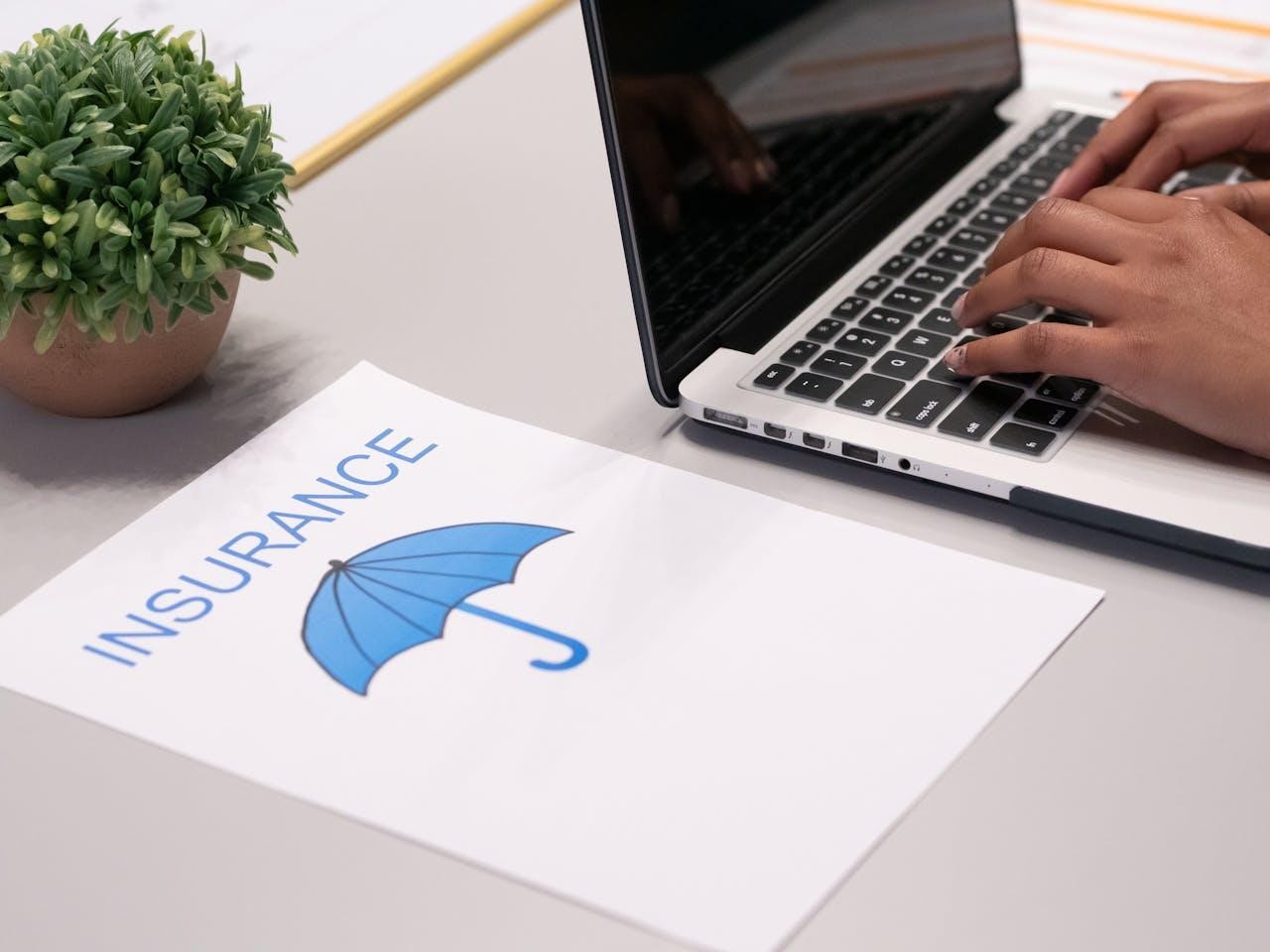 A paper beside a laptop 
