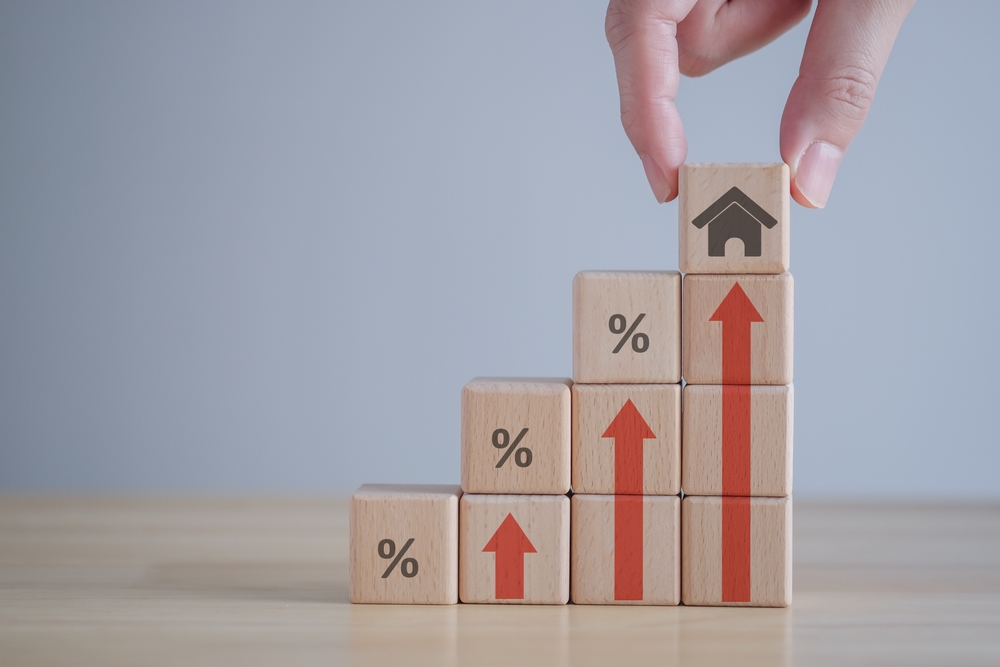 percent and house image printed on building blocks forming a staircase