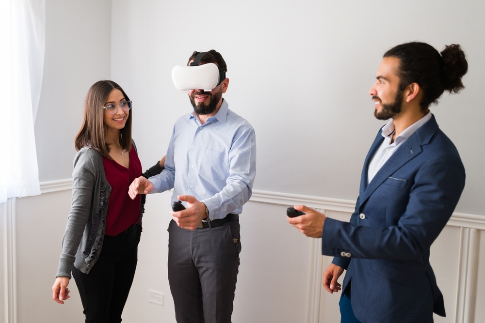 An agent doing a demo of a VR headset to clients