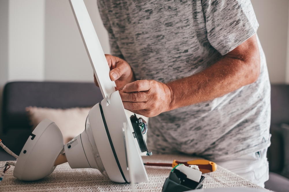 A person cleaning ceiling fans