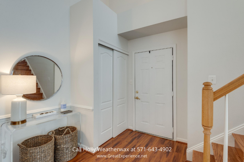 Reston, VA Condominium - Bright white walls and towering two-story ceilings throughout the living area of this condo in Reston, VA.