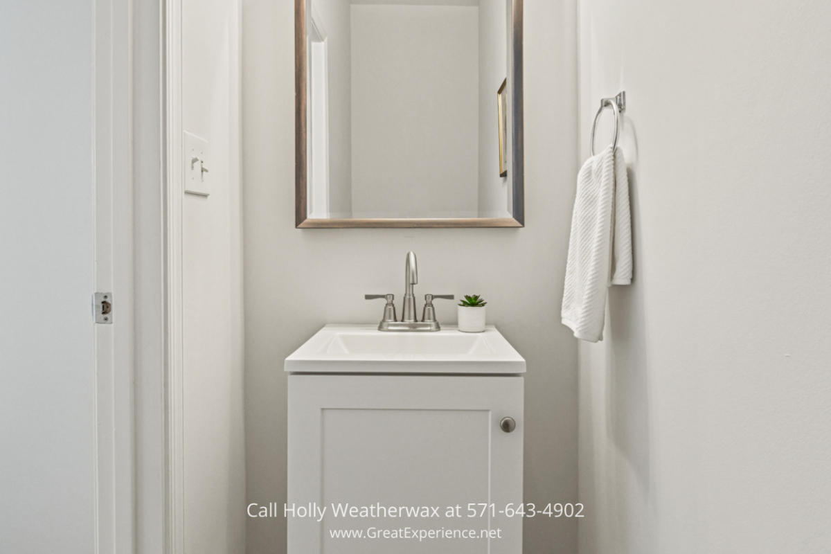 Welcome your guests in style with the beautifully designed hall powder room of this Reston VA condo for sale.