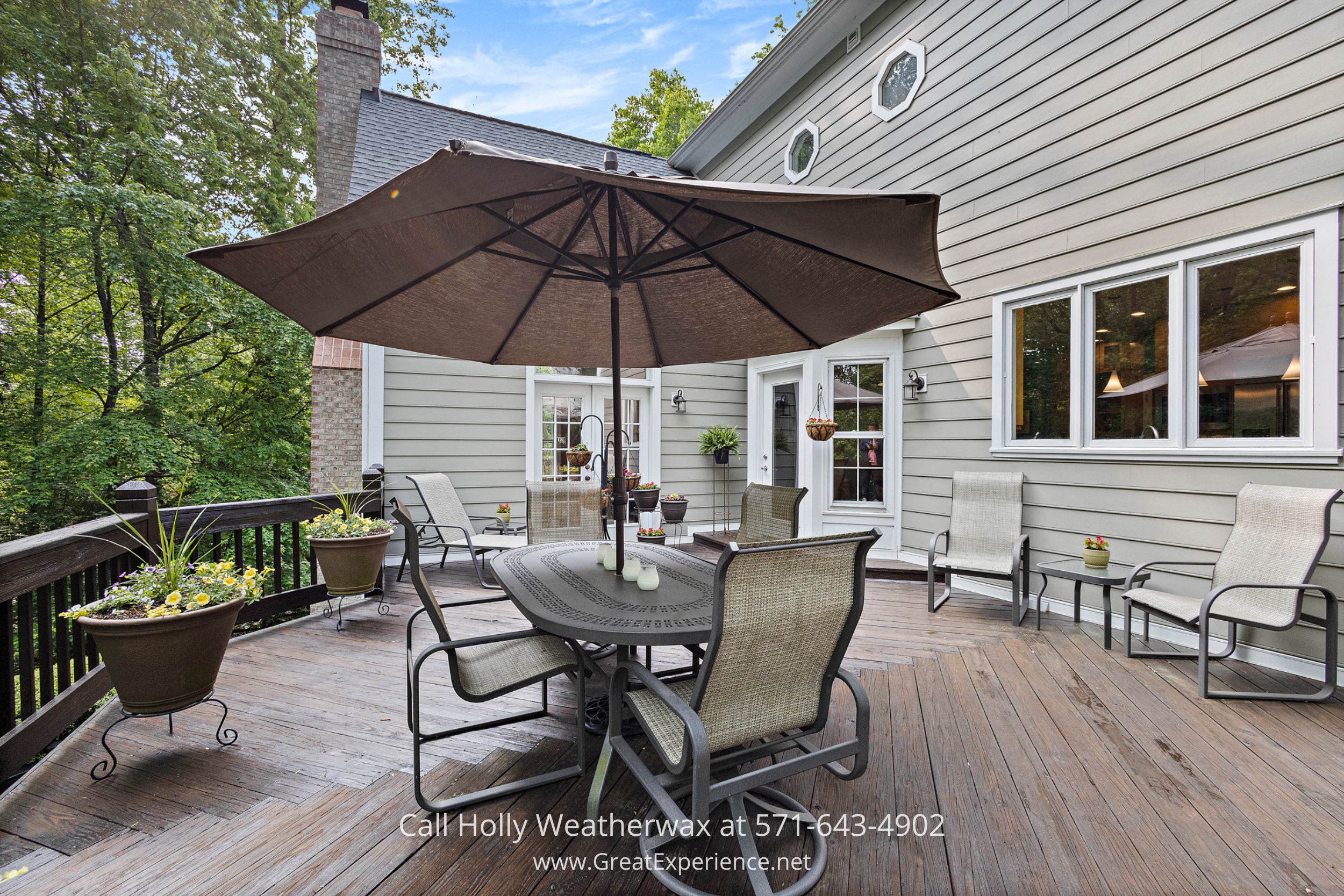 Relaxing outdoor deck with a stylish table, chairs, and umbrella