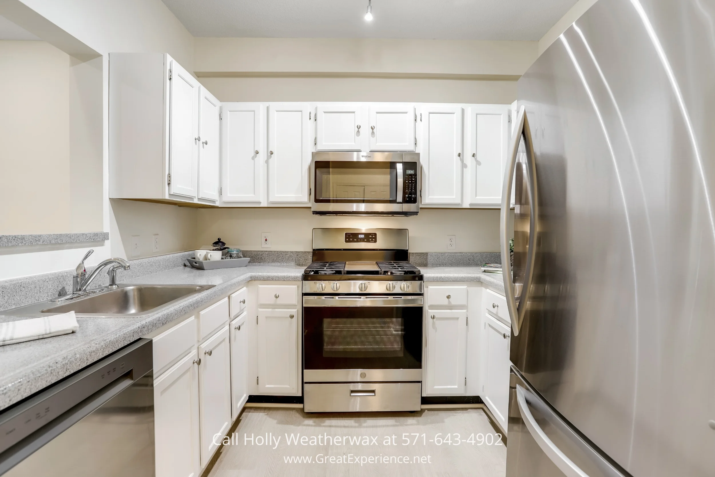 A sleek stainless steel stove, cabinets, and microwave in a kitchen