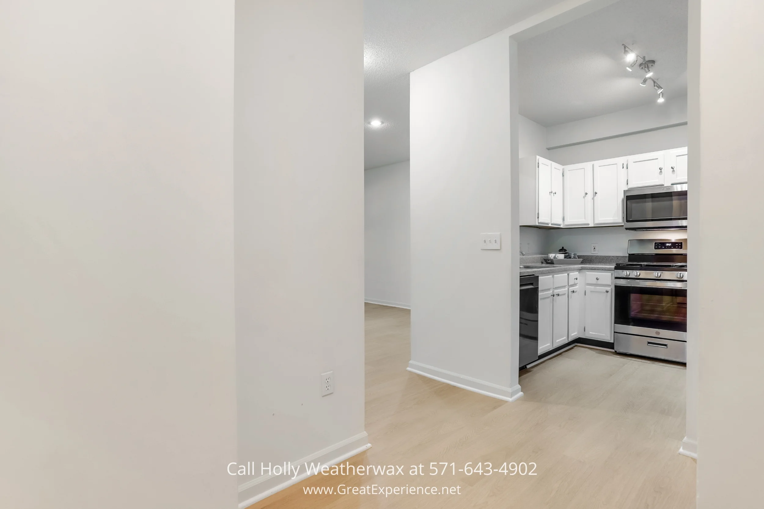 A sleek stainless steel stove, cabinets, and microwave in a kitchen