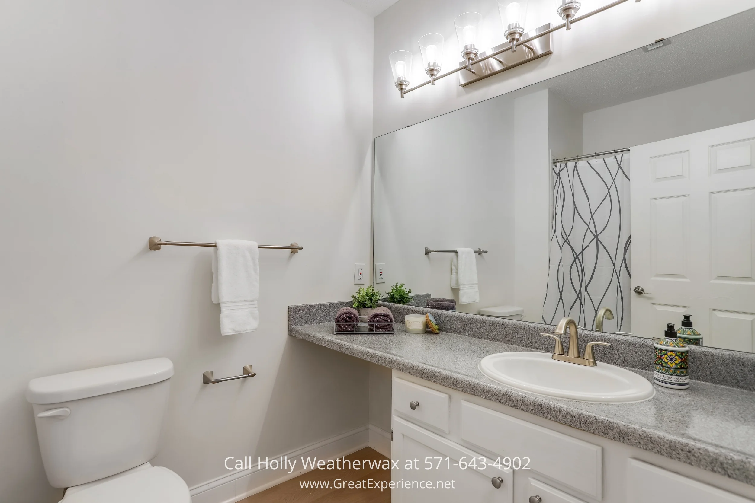 A tidy white room with a shelf and a sink