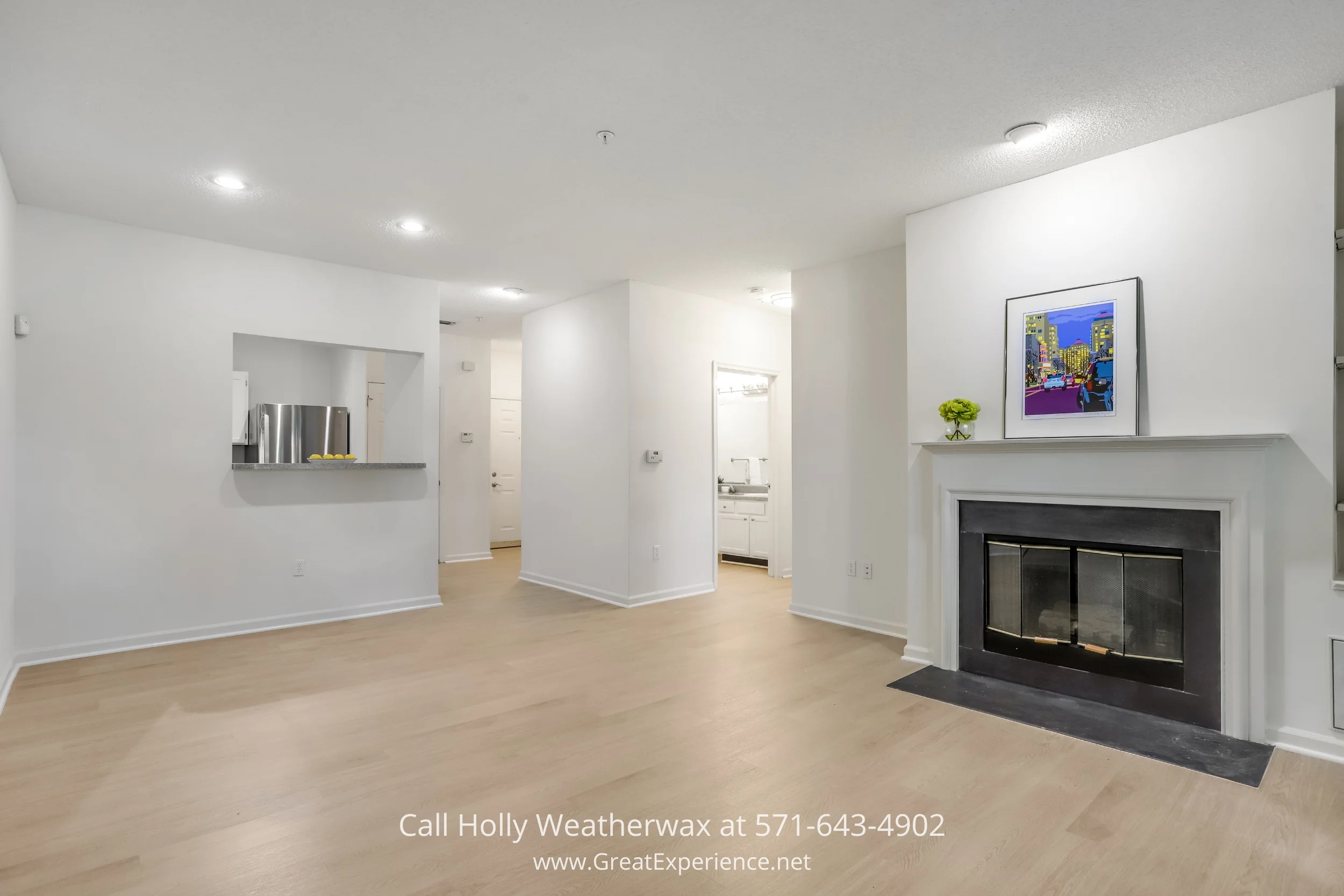 An inviting great room with a fireplace and white walls