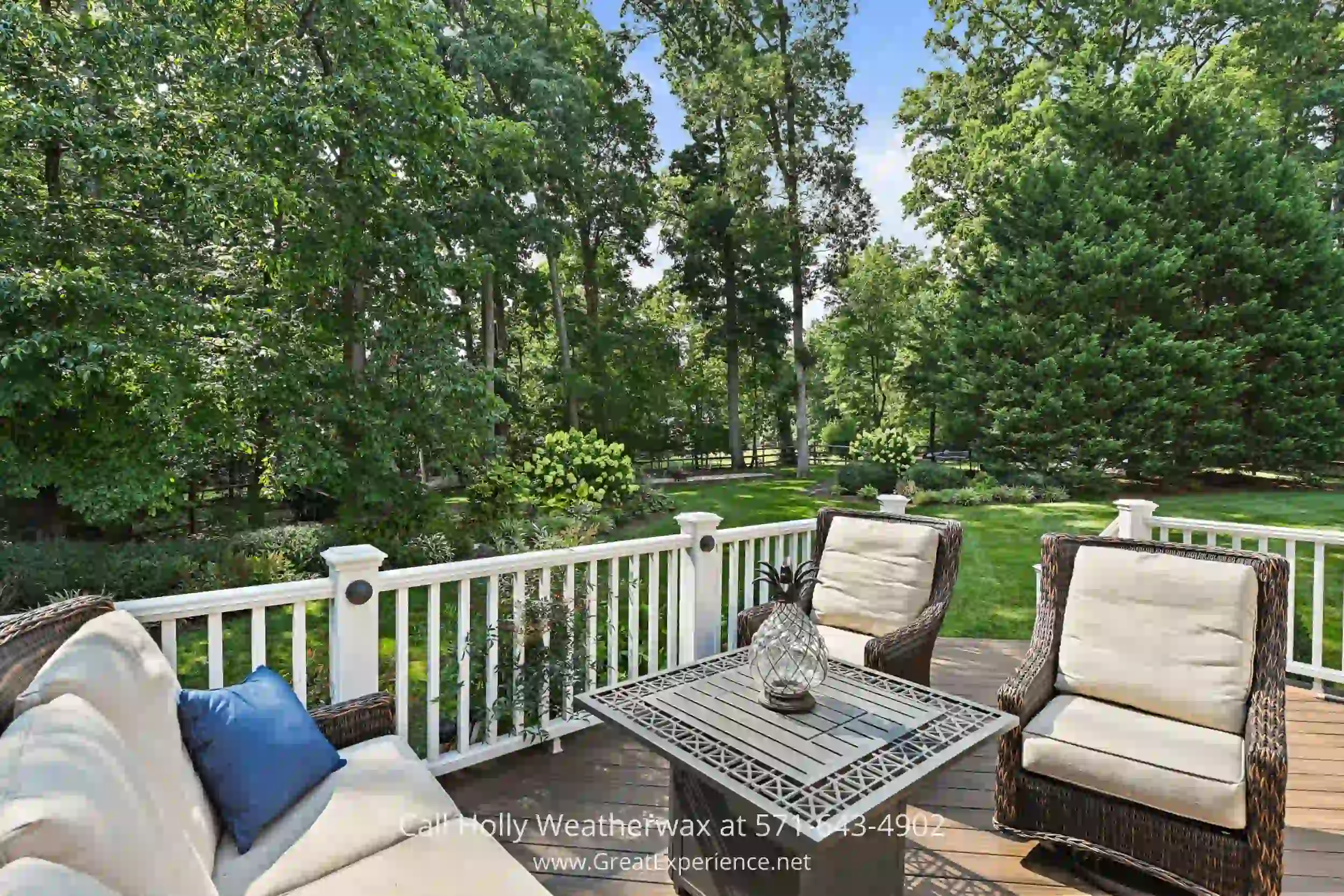 a deck with chairs and a table on it