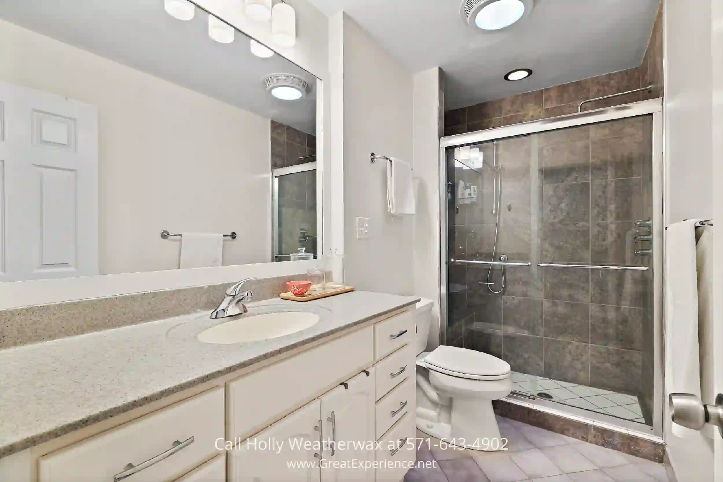 a bathroom with a sink, toilet, and shower