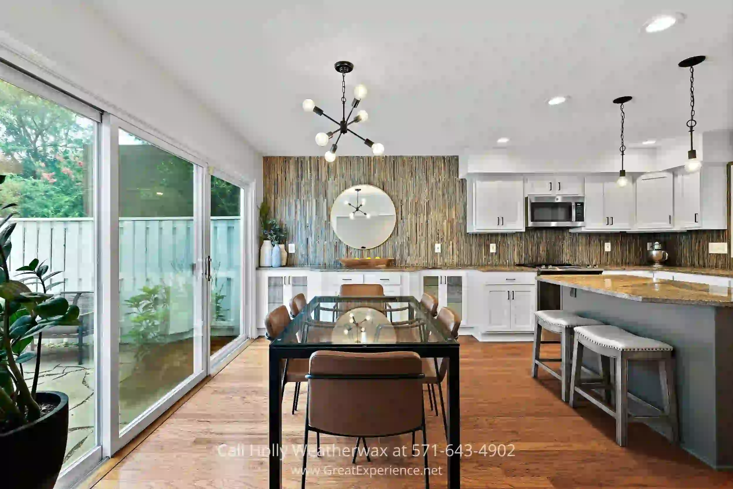 a dining room with a table and chairs and a clock on the wall