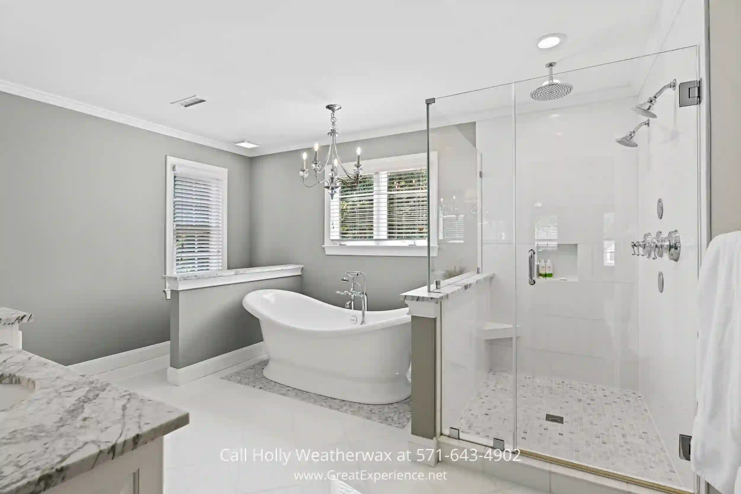 a white bath tub sitting next to a walk in shower