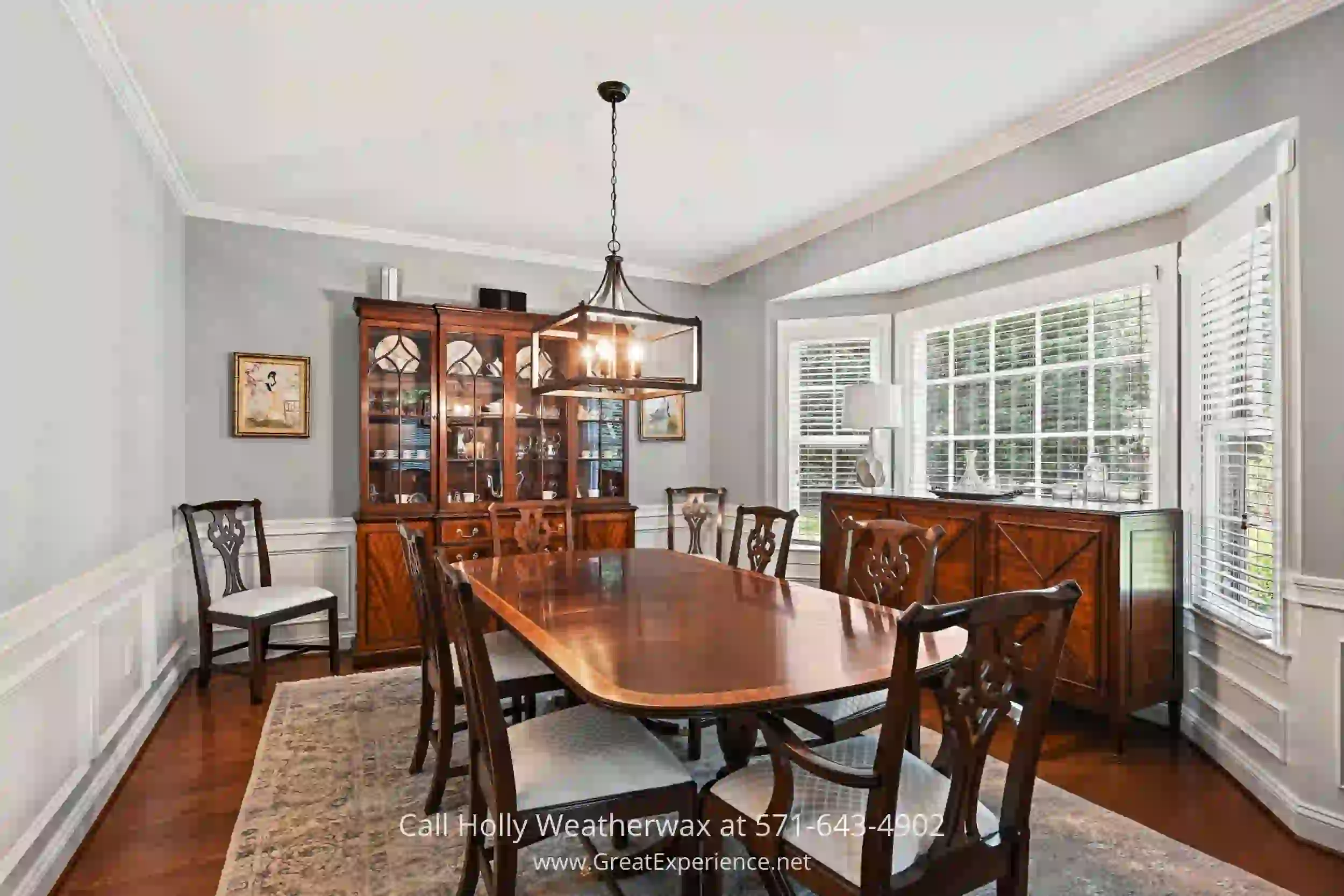 a dining room with a wooden table and chairs