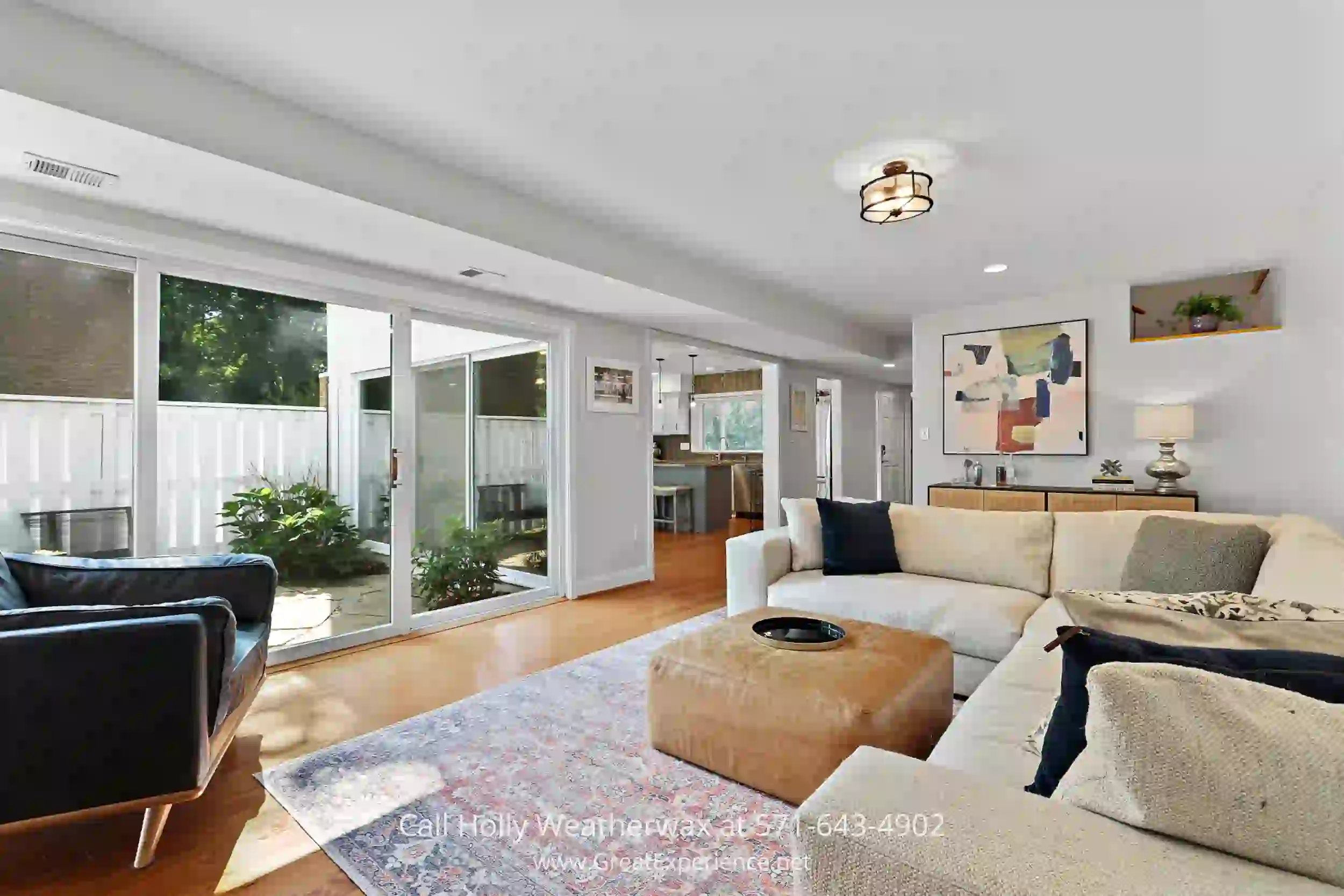 a living room filled with furniture and a large window