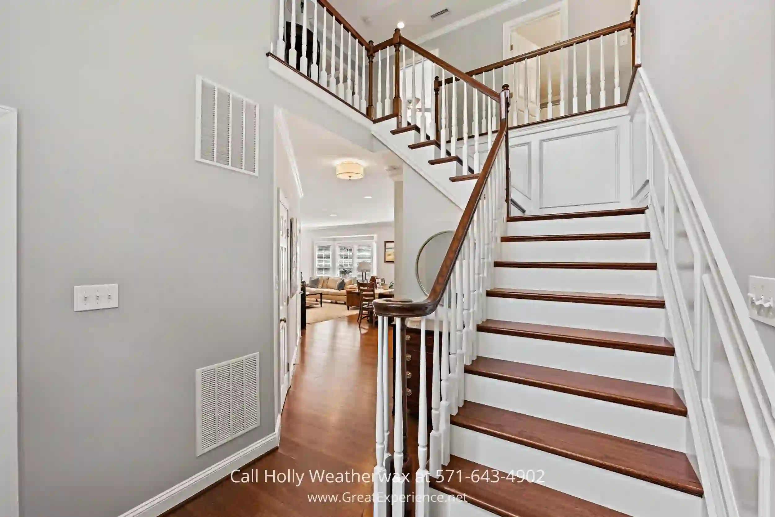 a staircase leading to a living room and dining room