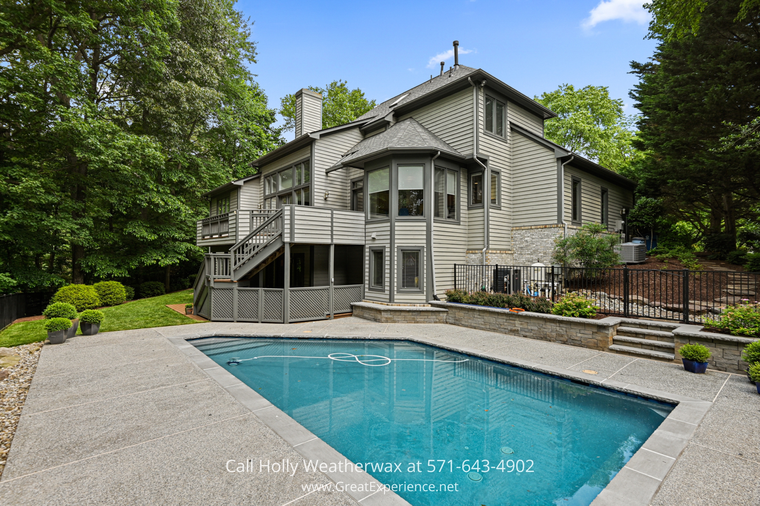 a large house with a pool in front of it