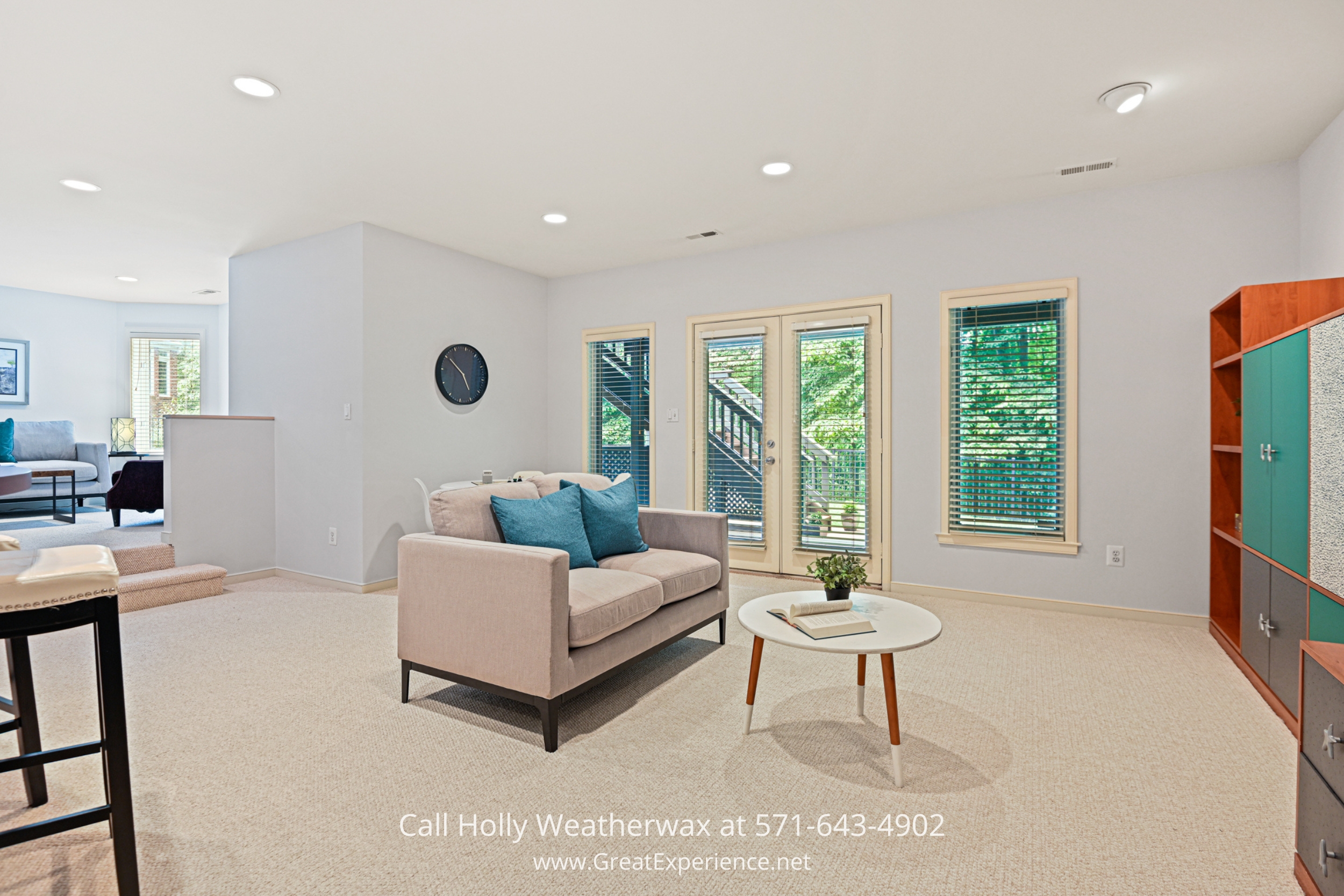 a family room filled with furniture and lots of windows