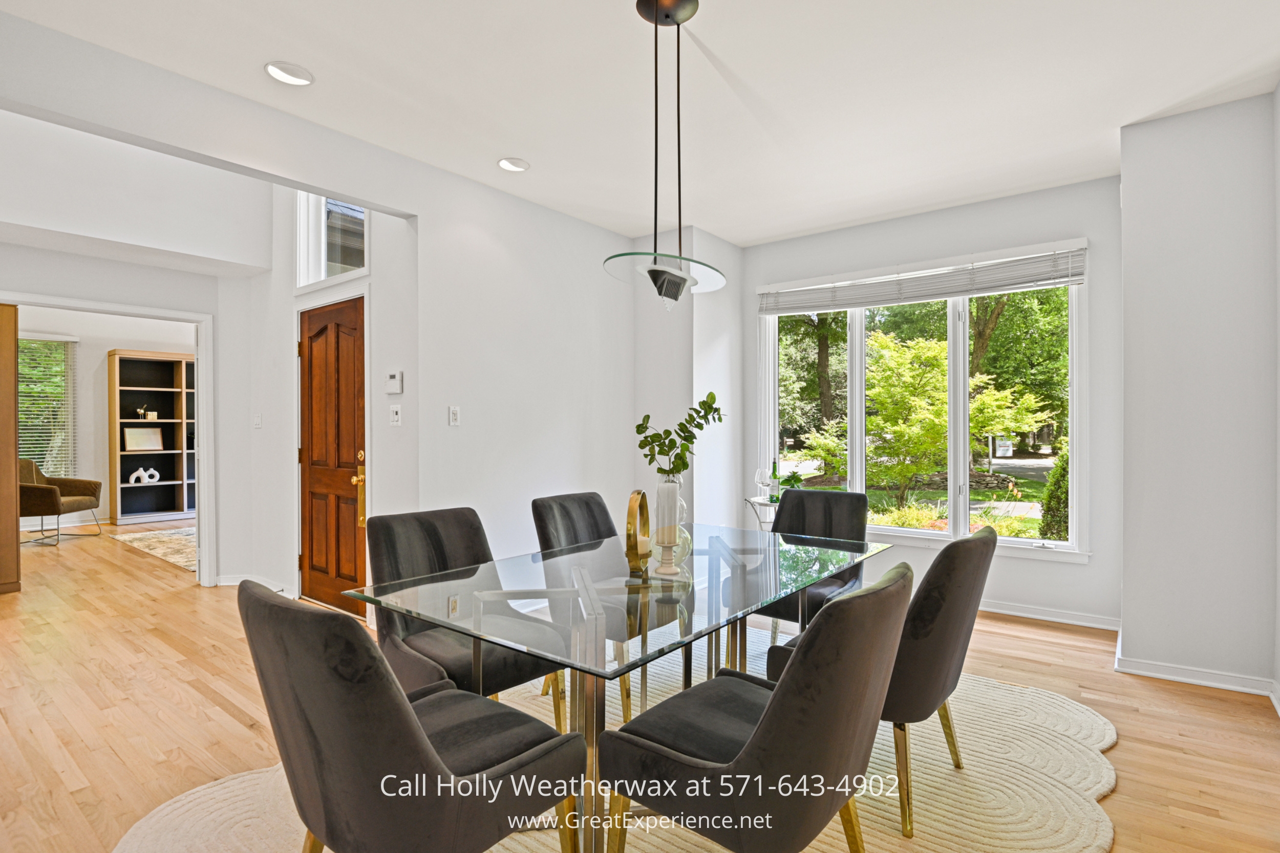 a dining room with a glass table and chairs