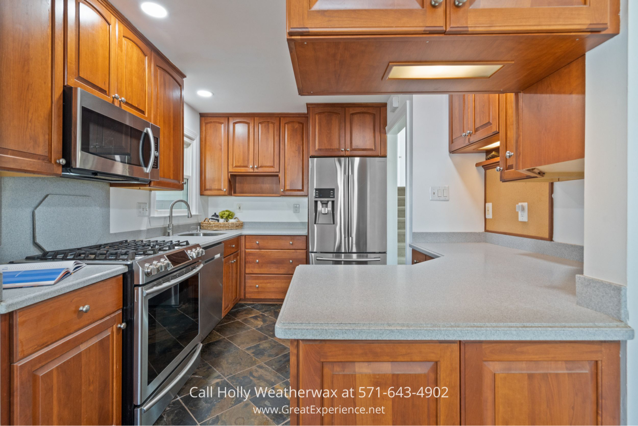 Updated kitchen with warm wood cabinets, stainless steel appliances, and slate tile flooring in this Chantilly VA home for sale.