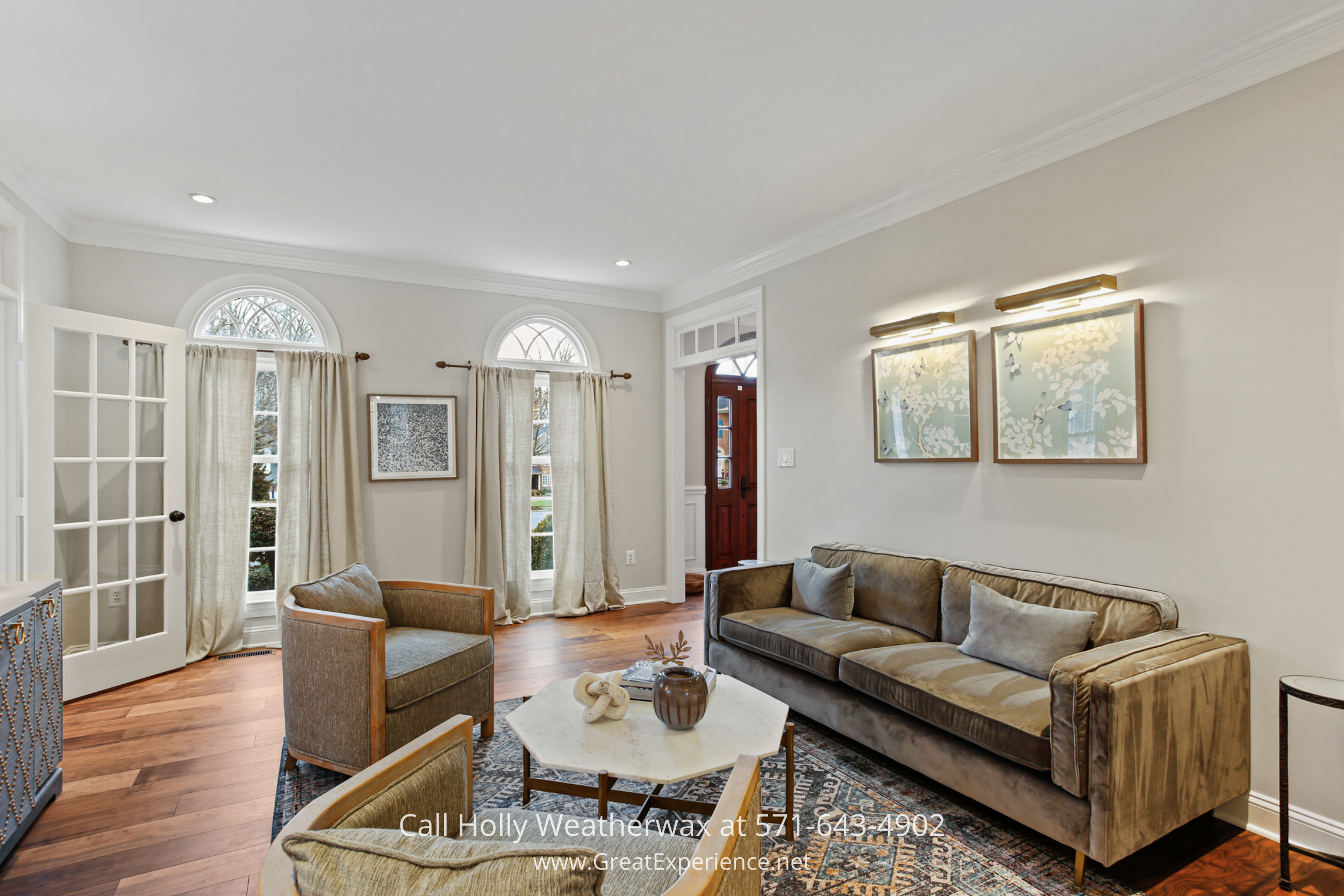 Finished lower-level recreation room at 1110 Round Pebble Lane, Reston, VA, featuring hardwood floors and a spacious entertainment area.