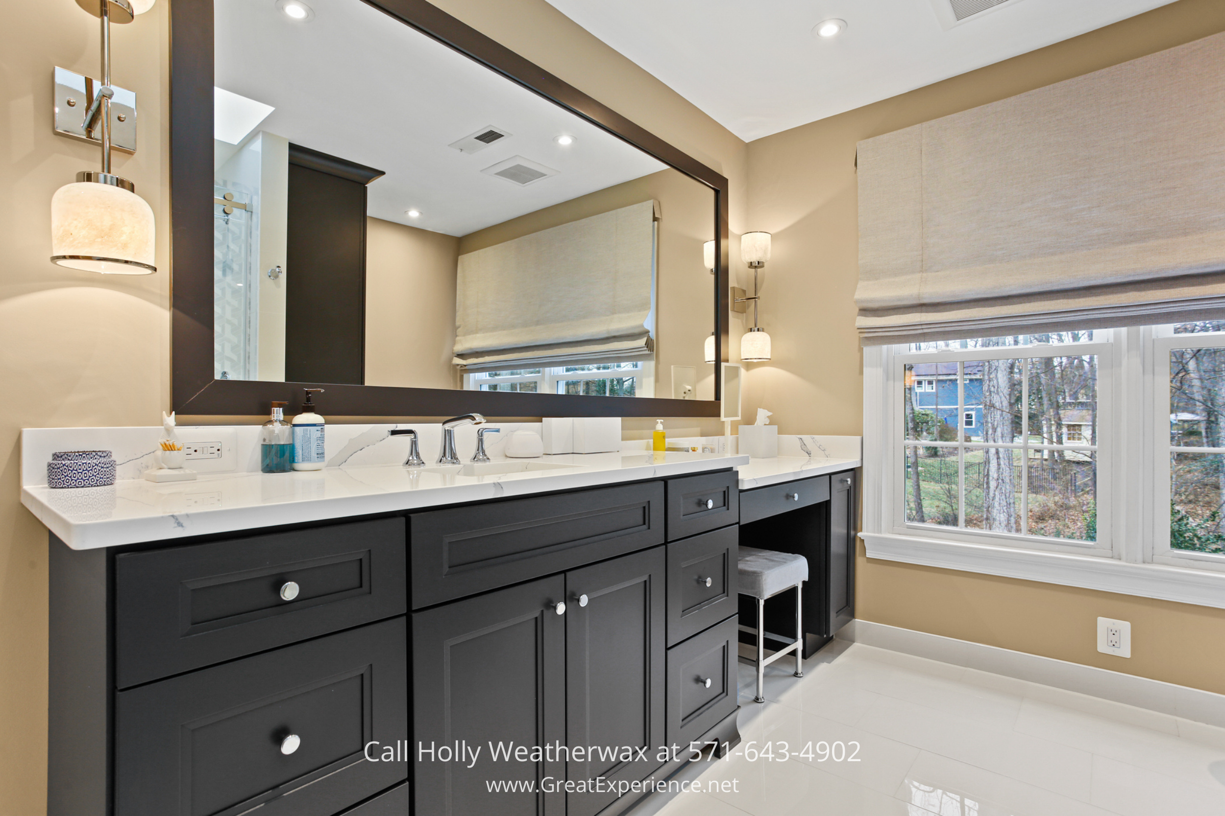 Updated bathroom at 1110 Round Pebble Lane, Reston, VA, featuring a double vanity, custom cabinetry, and modern lighting.