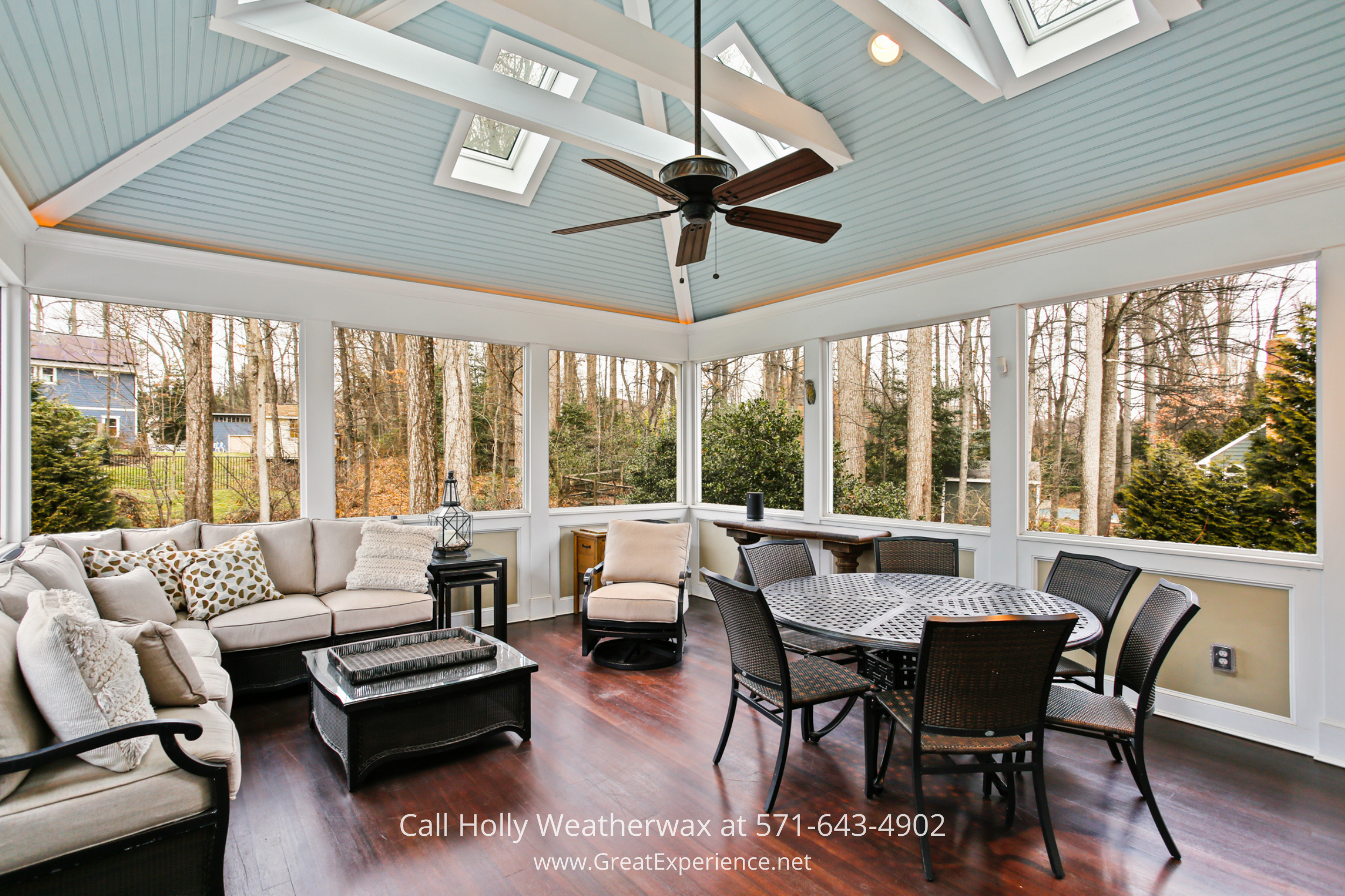 Screened porch at 1110 Round Pebble Lane, Reston, VA, featuring vaulted ceiling, skylights, and wooded views.