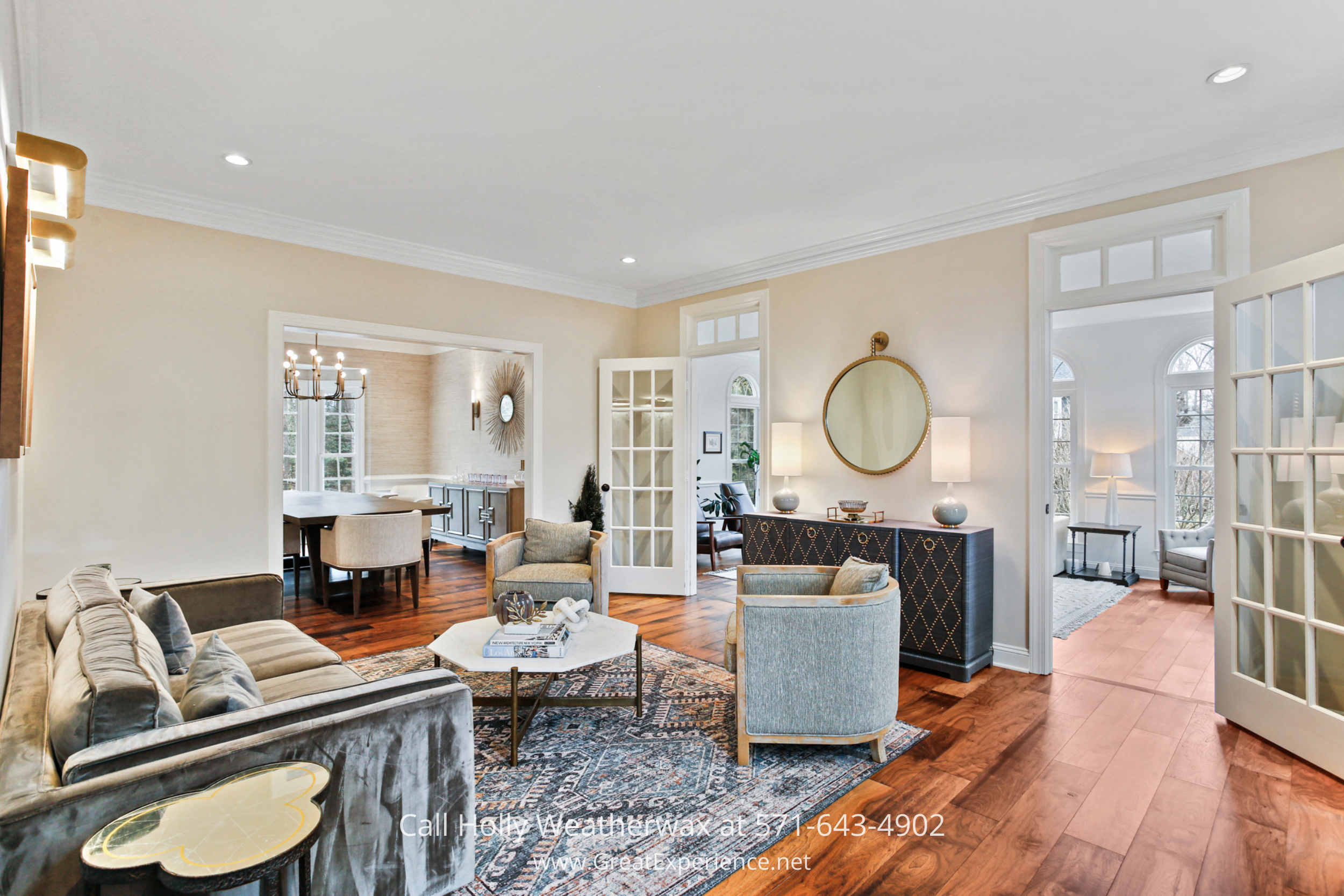 Elegant living room at 1110 Round Pebble Lane, Reston, VA, with hardwood floors, French doors, and open flow to dining and sitting areas.