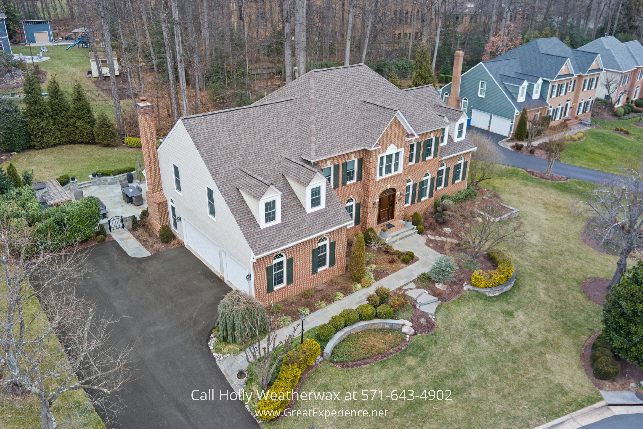 Aerial view of 1110 Round Pebble Lane, Reston, VA, showcasing a brick luxury home on a cul-de-sac with landscaped grounds in North Reston.