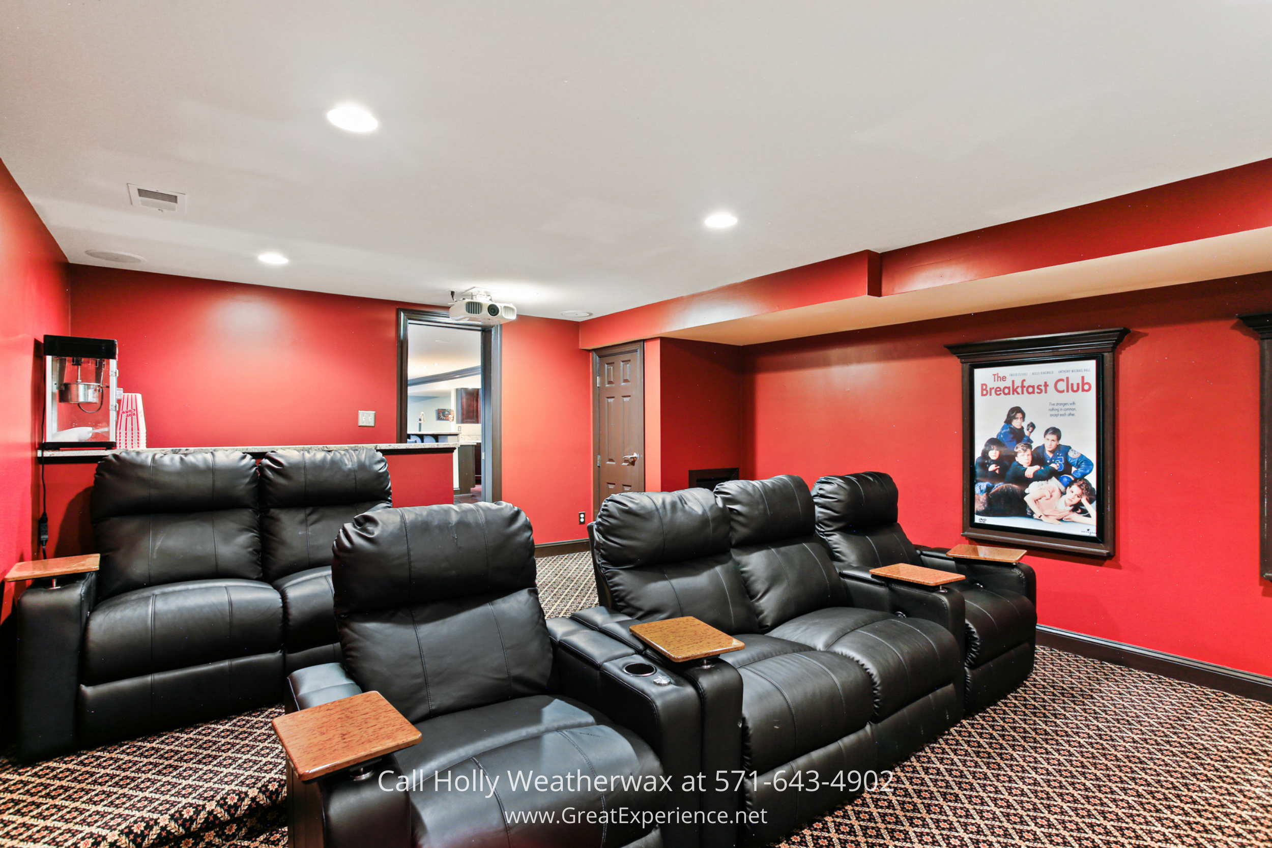 Home theater at 1110 Round Pebble Lane, Reston, VA, featuring tiered seating, projector, and dedicated media room setup.