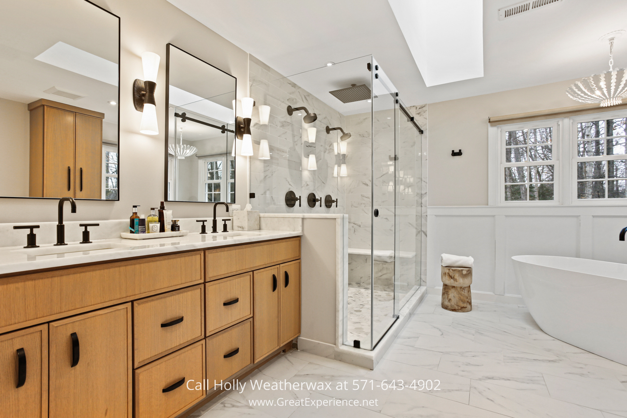 Primary bathroom at 1110 Round Pebble Lane, Reston, VA, featuring a double vanity, glass shower, and freestanding soaking tub.
