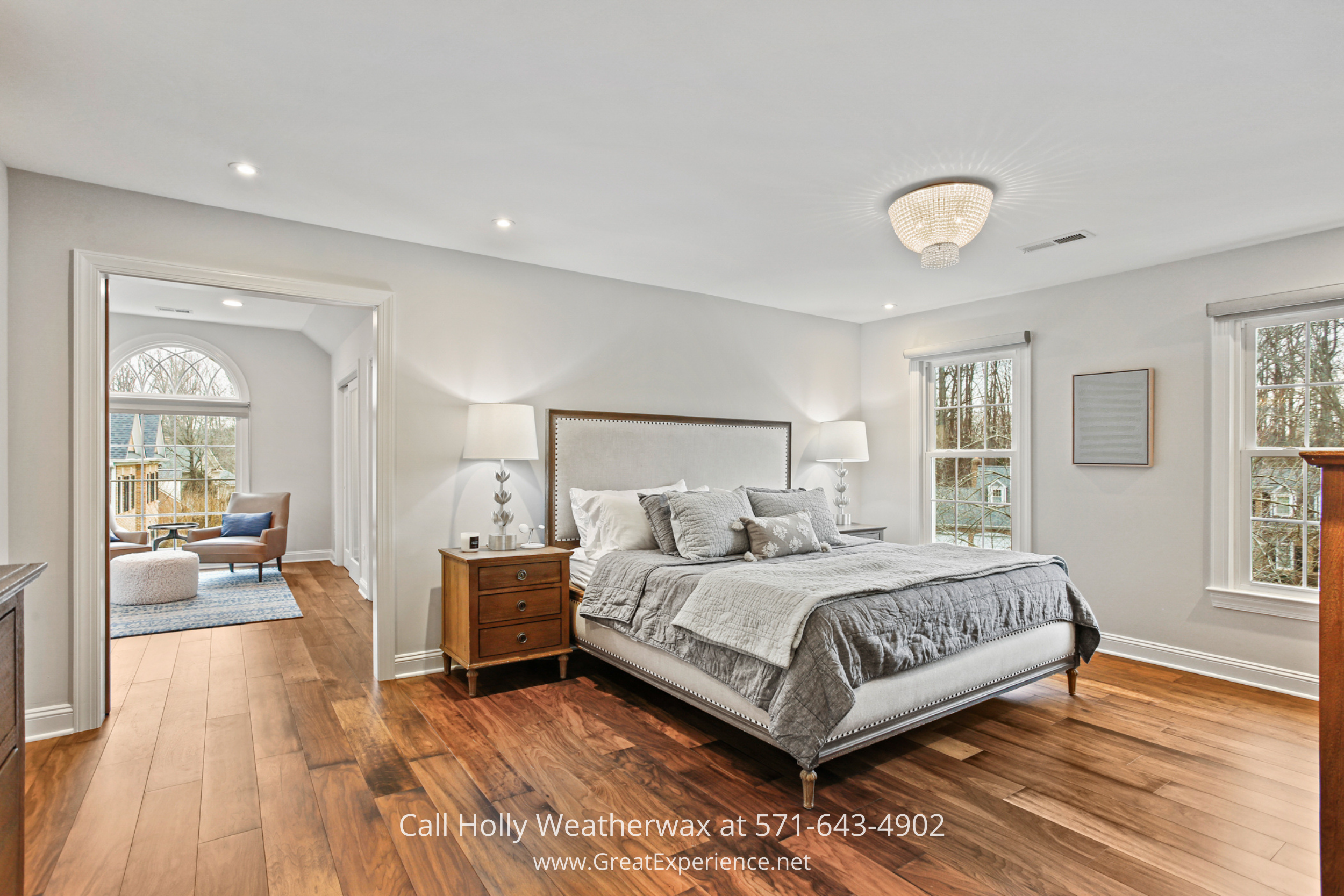 Spacious primary bedroom at 1110 Round Pebble Lane, Reston, VA, featuring hardwood floors, large windows, and a private sitting area.