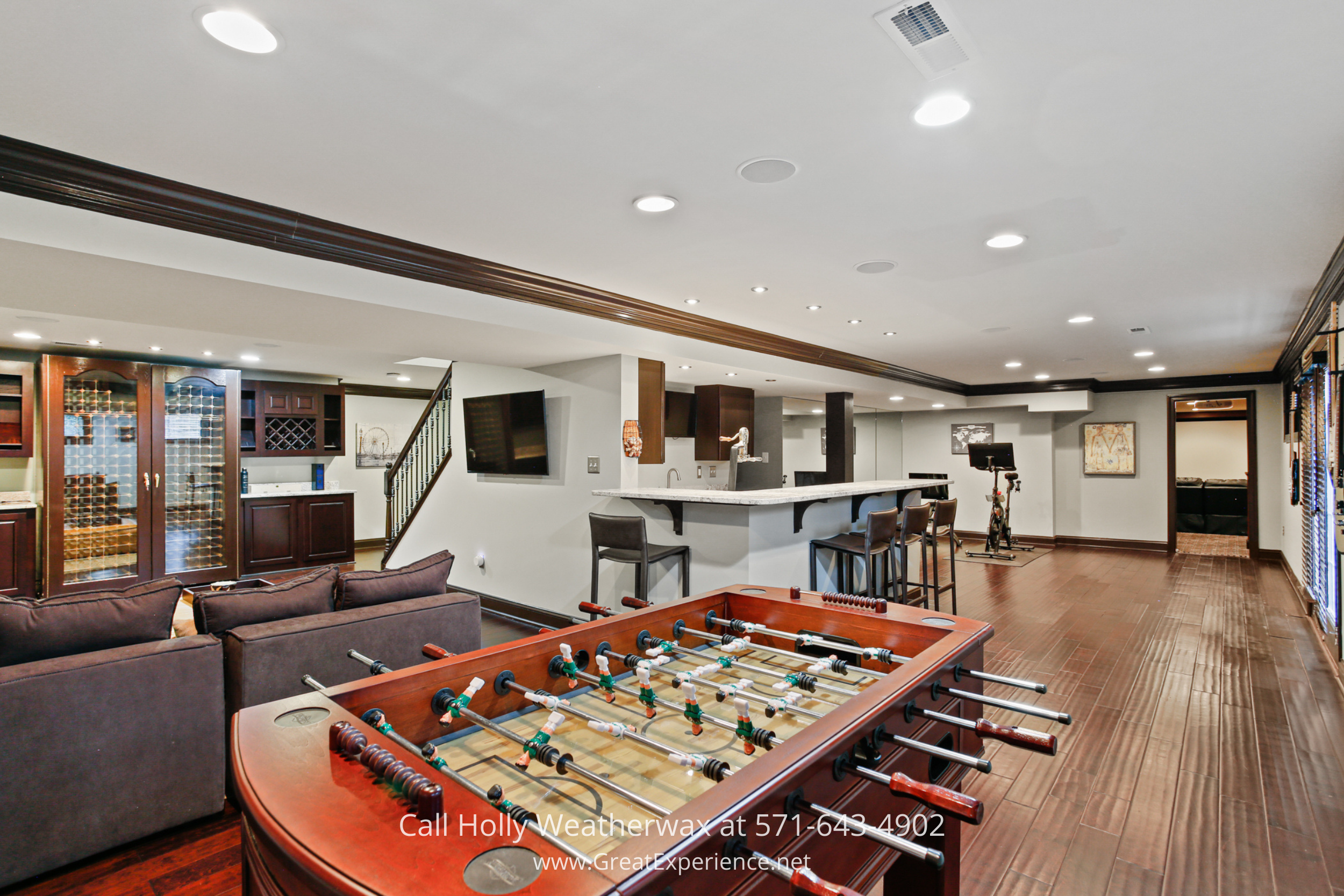Lower-level entertainment area at 1110 Round Pebble Lane, Reston, VA, featuring a game space, wet bar, and open recreation layout.