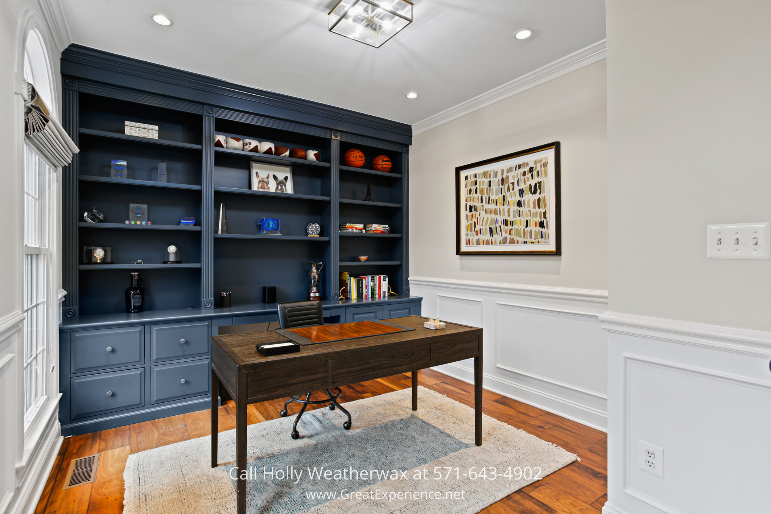 Home office at 1110 Round Pebble Lane, Reston, VA, featuring custom built-in shelving, hardwood floors, and a dedicated workspace.