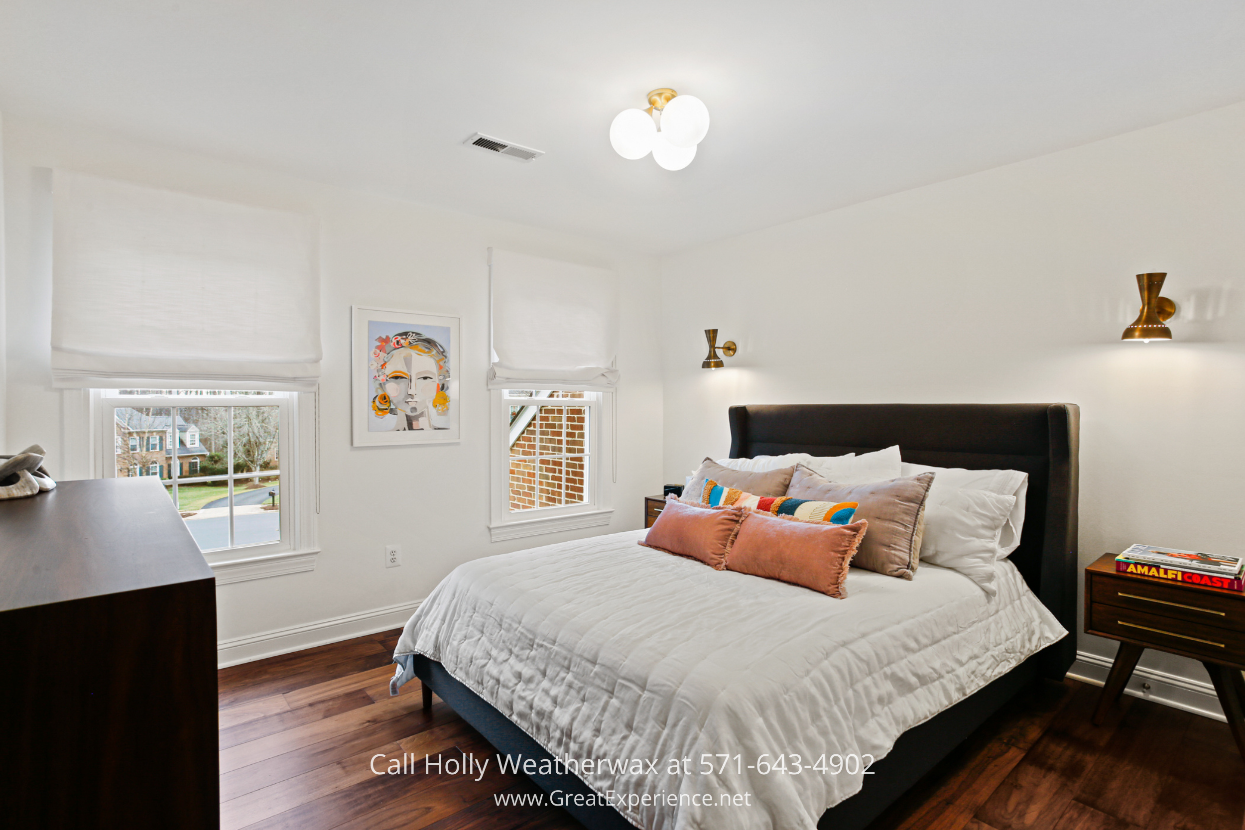 Bedroom at 1110 Round Pebble Lane, Reston, VA, featuring hardwood floors, large windows, and modern lighting.