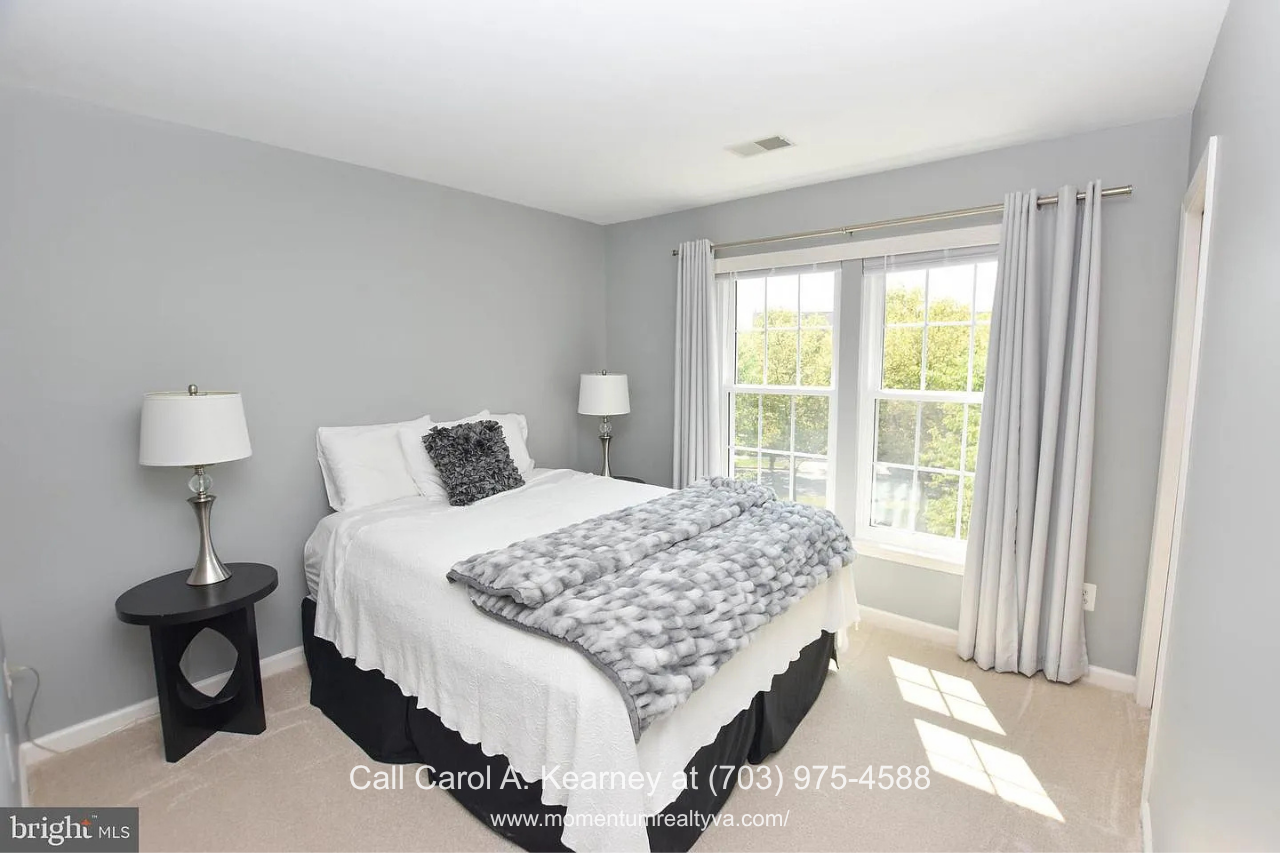 Primary Bedroom – 25474 Brickell Dr Bright primary bedroom at 25474 Brickell Dr in South Riding, Chantilly, VA, featuring large windows, abundant natural light, and neutral finishes.