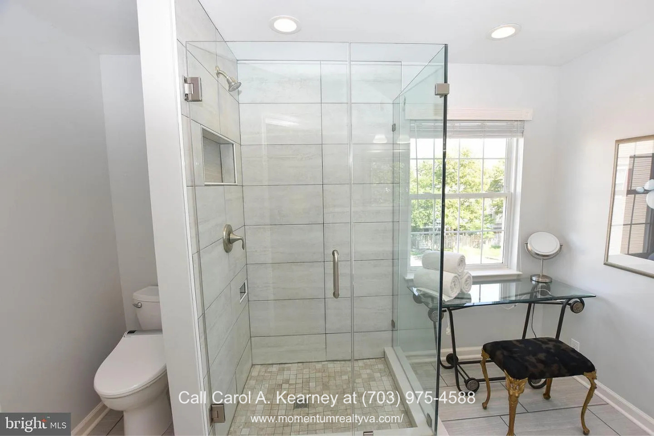 Primary Bathroom – 25474 Brickell Dr Primary bathroom at 25474 Brickell Dr in South Riding, Chantilly, VA, featuring a spacious glass-enclosed tiled shower and bright natural light.