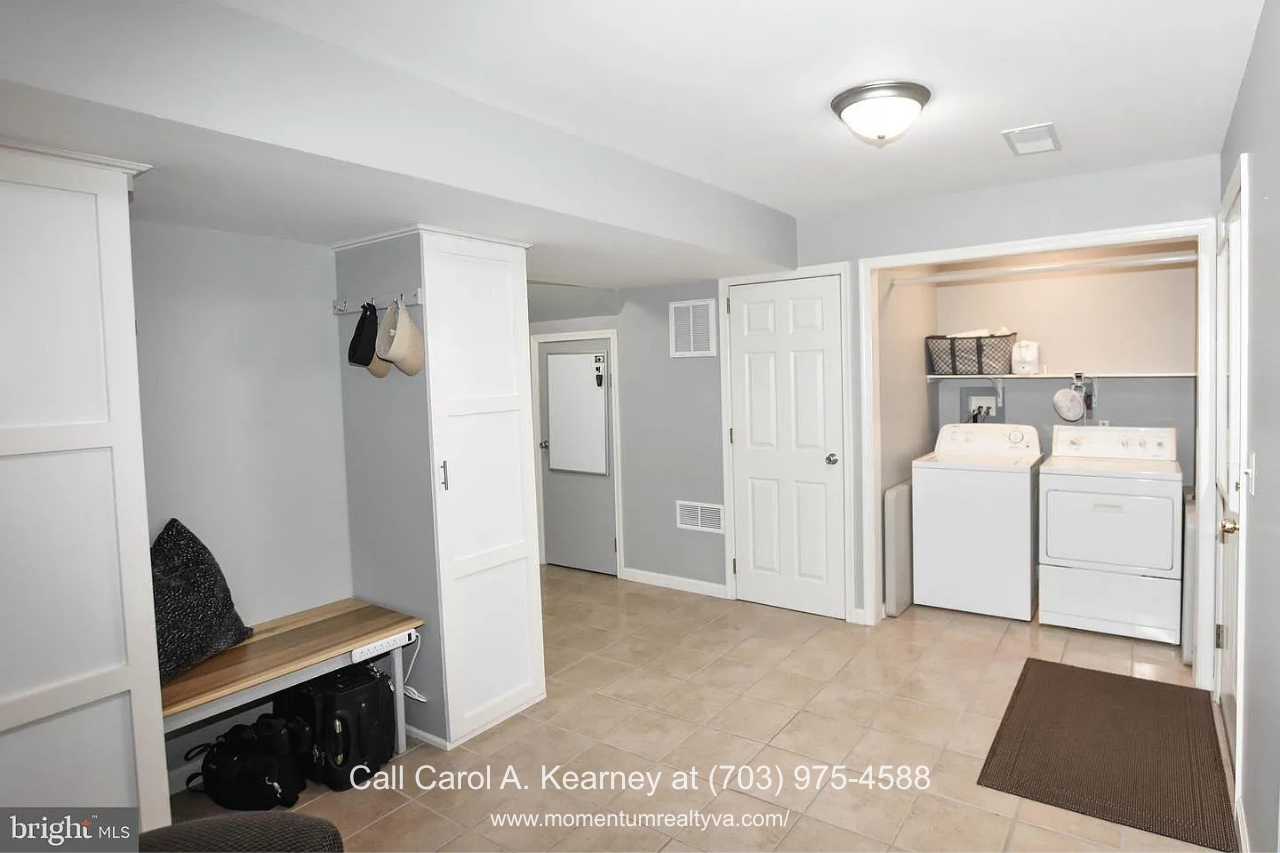 Laundry and Utility Room – 25474 Brickell Dr Spacious laundry and utility room at 25474 Brickell Dr in South Riding, Chantilly, VA, featuring a washer and dryer, built-in storage, and additional functional space.