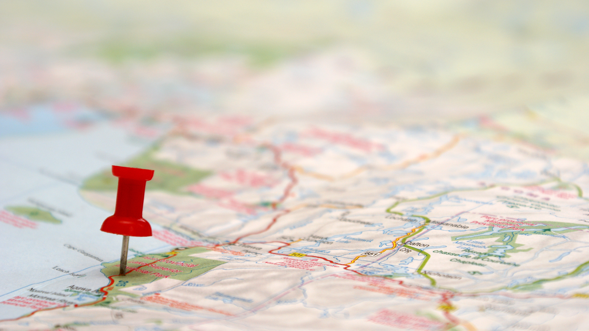 A red pin is placed on a map, symbolizing road trip planning tips for travelers starting from Reno.
