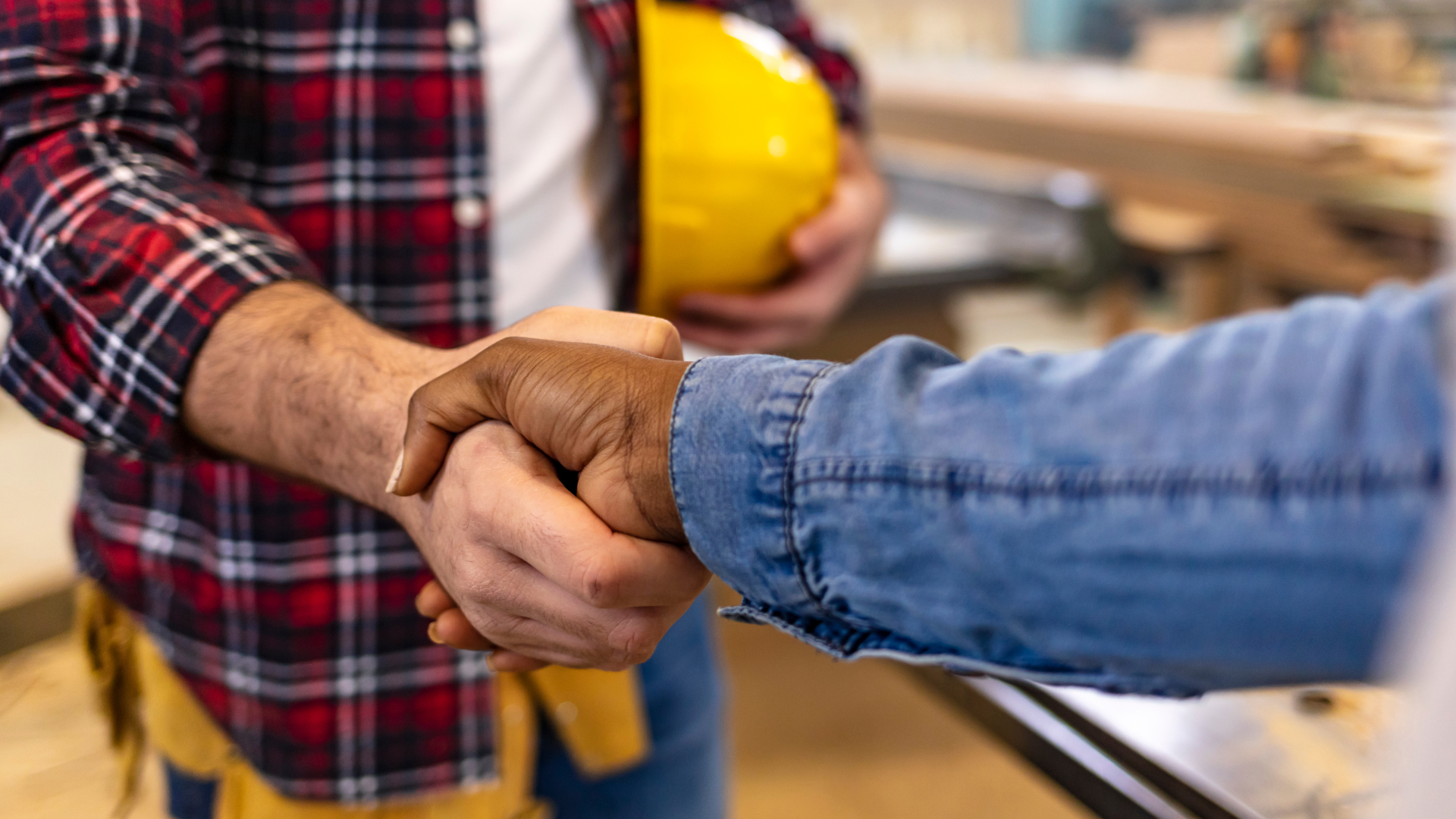 Hire Help Home Repairs Two people shake hands, one holding a hard hat, agreeing on home repairs.