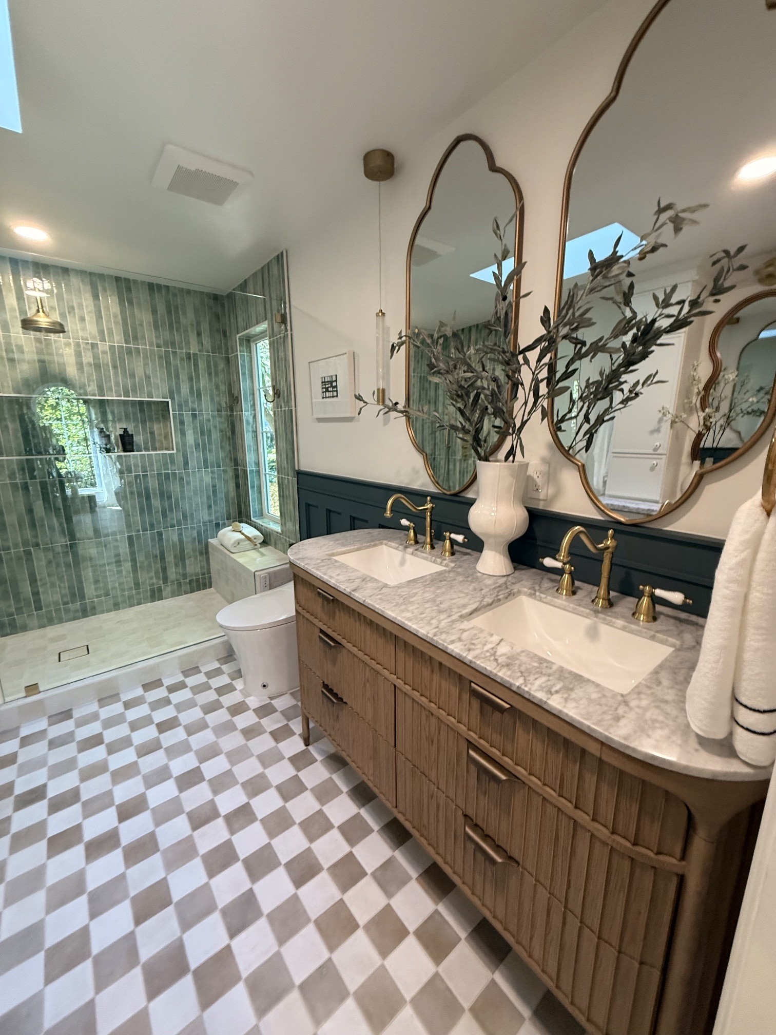 Bathroom vanity with layered lighting and neutral finishes in Hillsborough